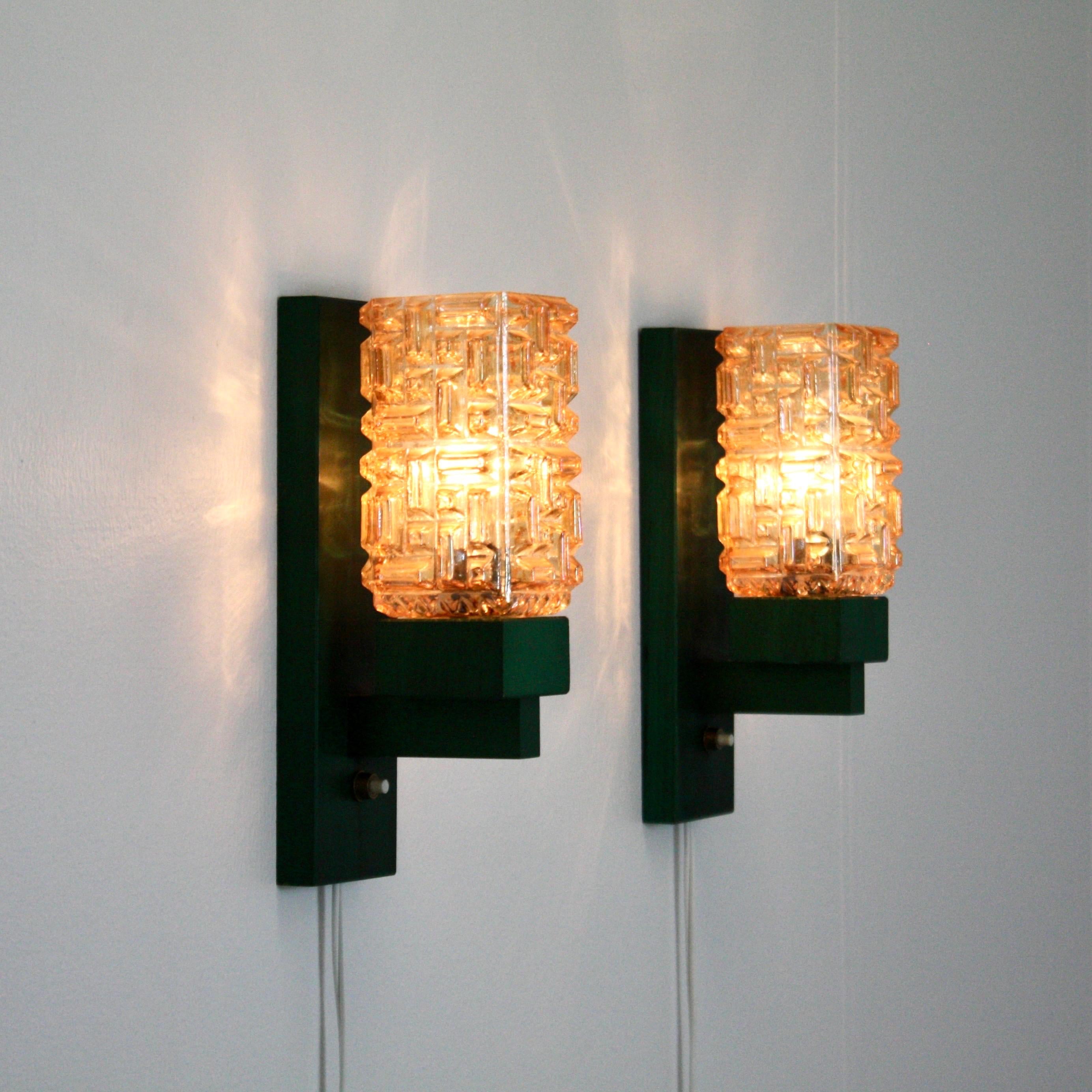 Exquisite set of Danish Modern wall lamps in green stained Scandinavian beech wood and amber colored glass shades. The sconces were made in the 1970s by the Danish workshop 'Vitrika'. 

* A set (2) green stained wood wall lamps with amber glass