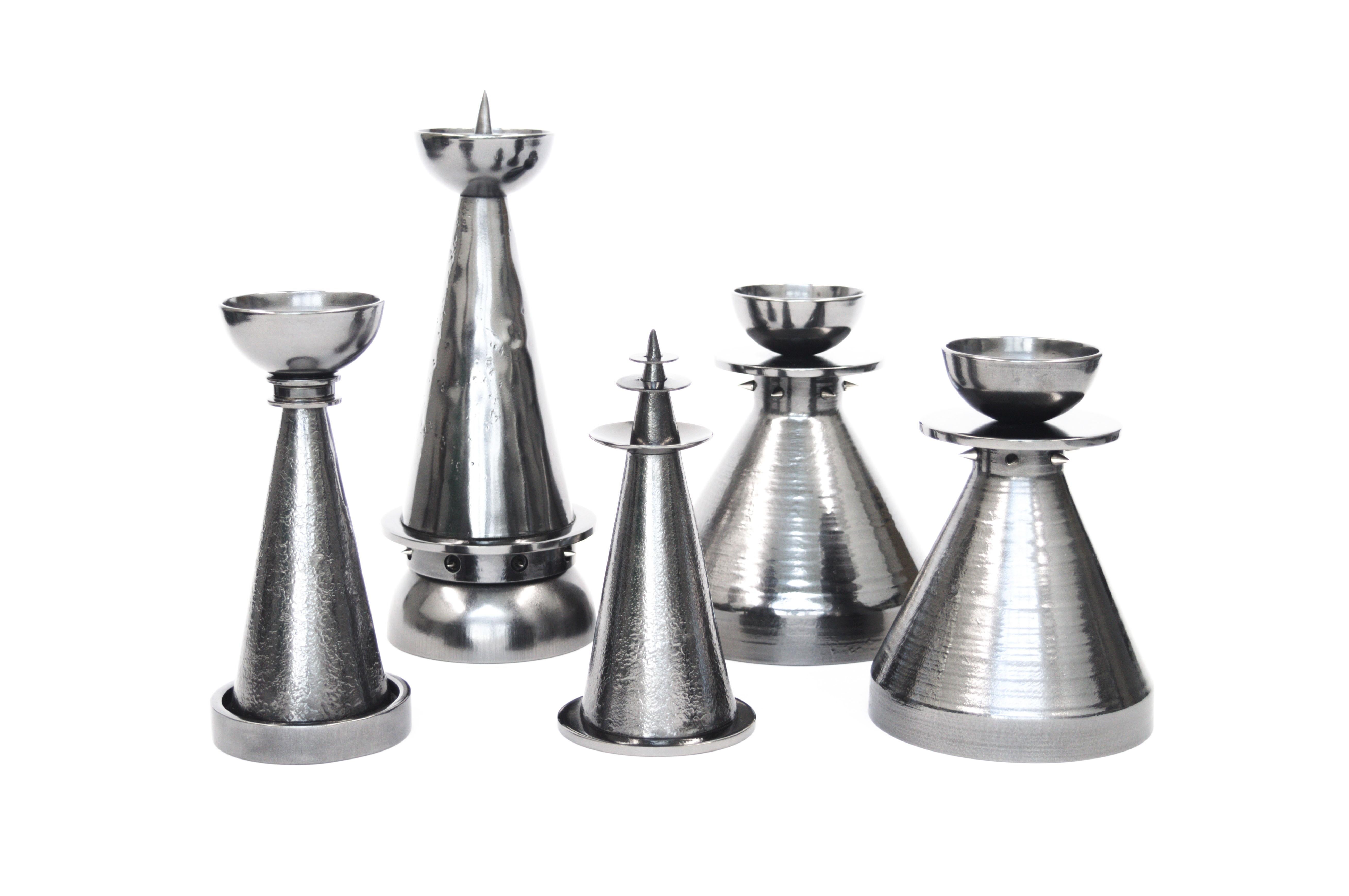 The Vulcan Candlesticks are a set of five futuristic candle holders, created with a combination of industrial forged steel components. Each variant is designed to stack and interact with one other, creating many different combinations for