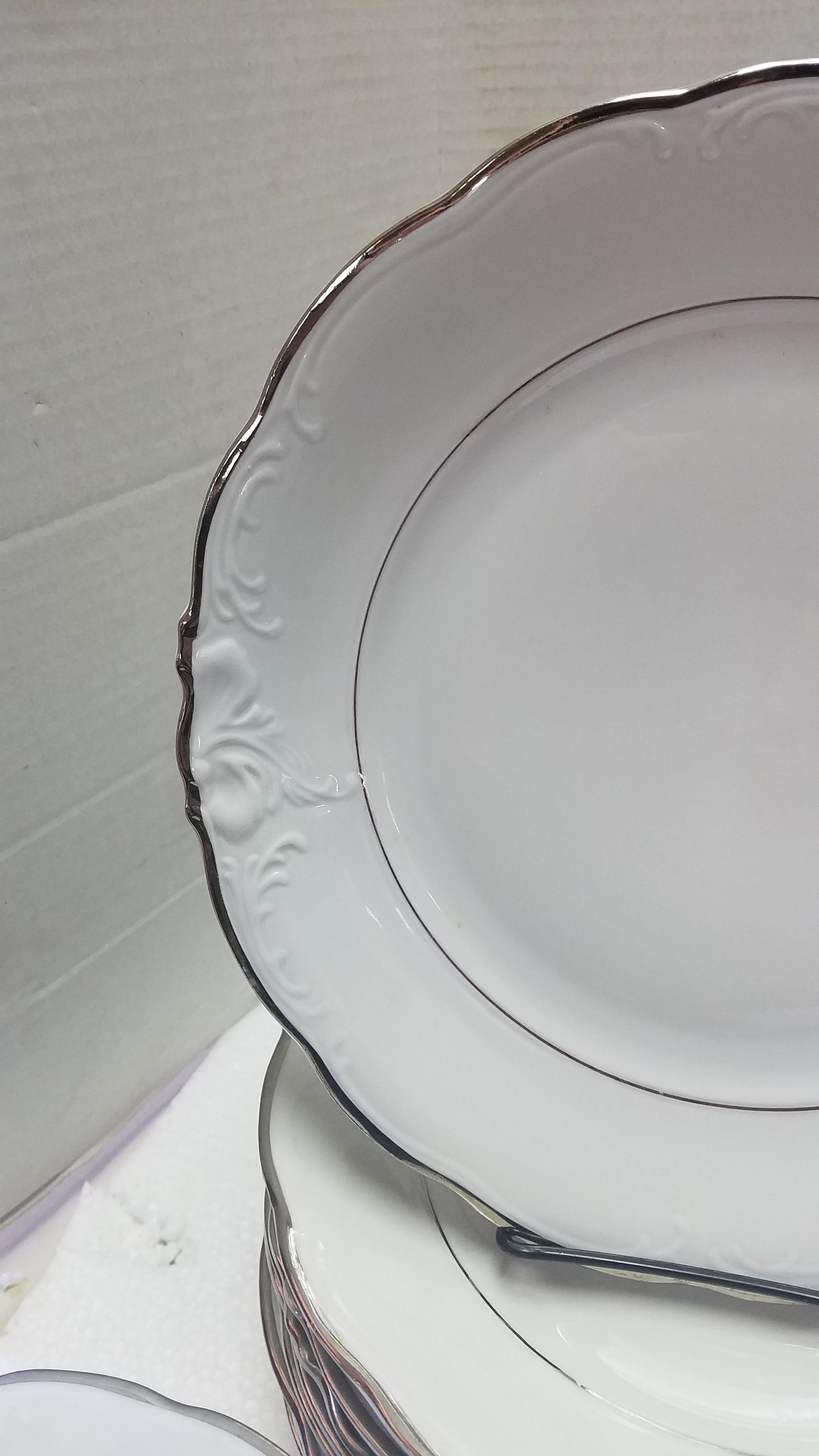 Set of 66 pieces of Walbrzych China from the Walbrzych Porcelain Factory in Poland. White porcelain with silver leaf details. Raised design, see all photos. The set was never used but some of the silver is worn off on one of the salad plates (see