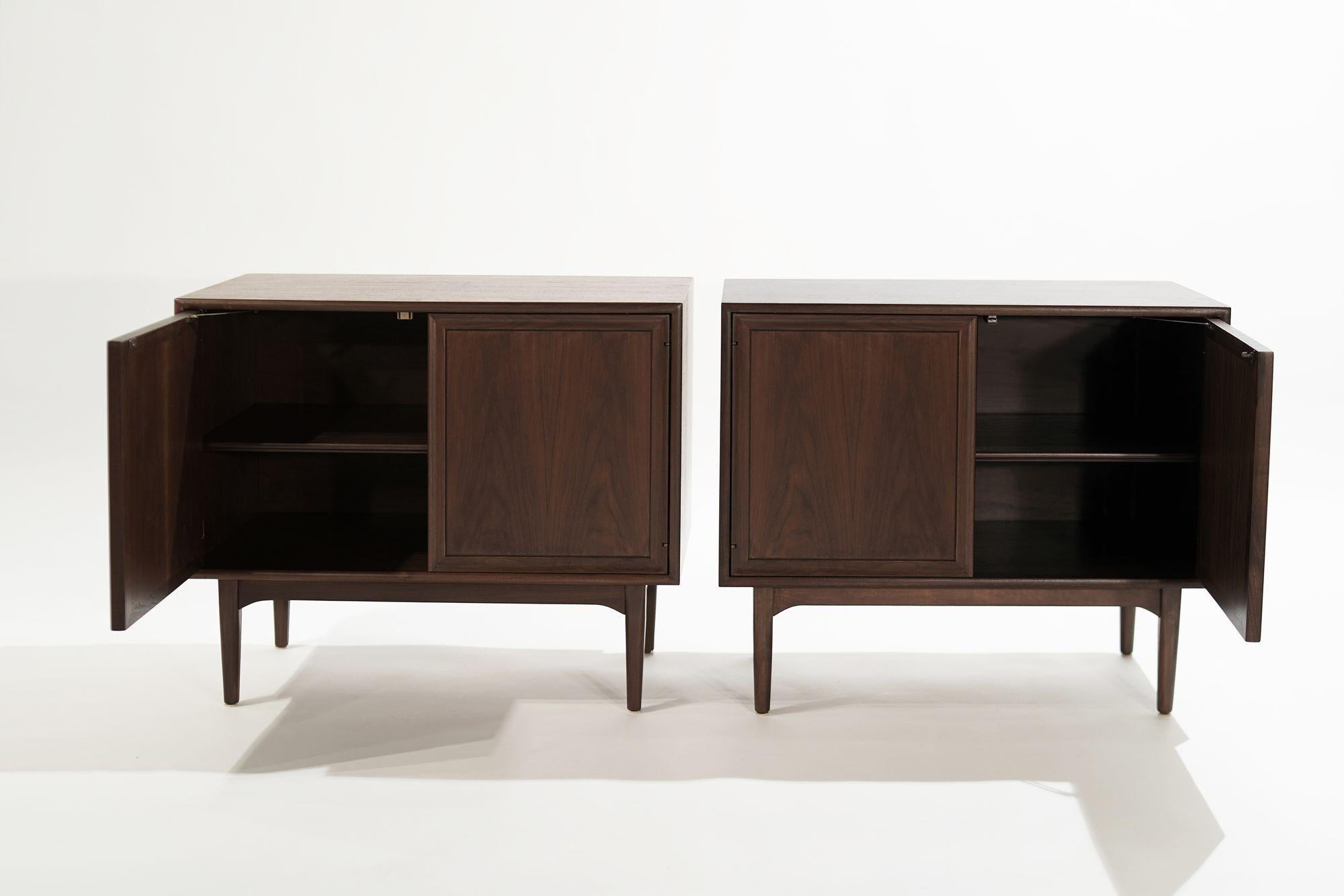 Elevate your interior with the timeless allure of these exquisite Walnut cabinets, masterfully crafted by the renowned Kipp Stewart for Drexel in the mid-20th century. Embodying the epitome of mid-century design, these cabinets boast doors equipped