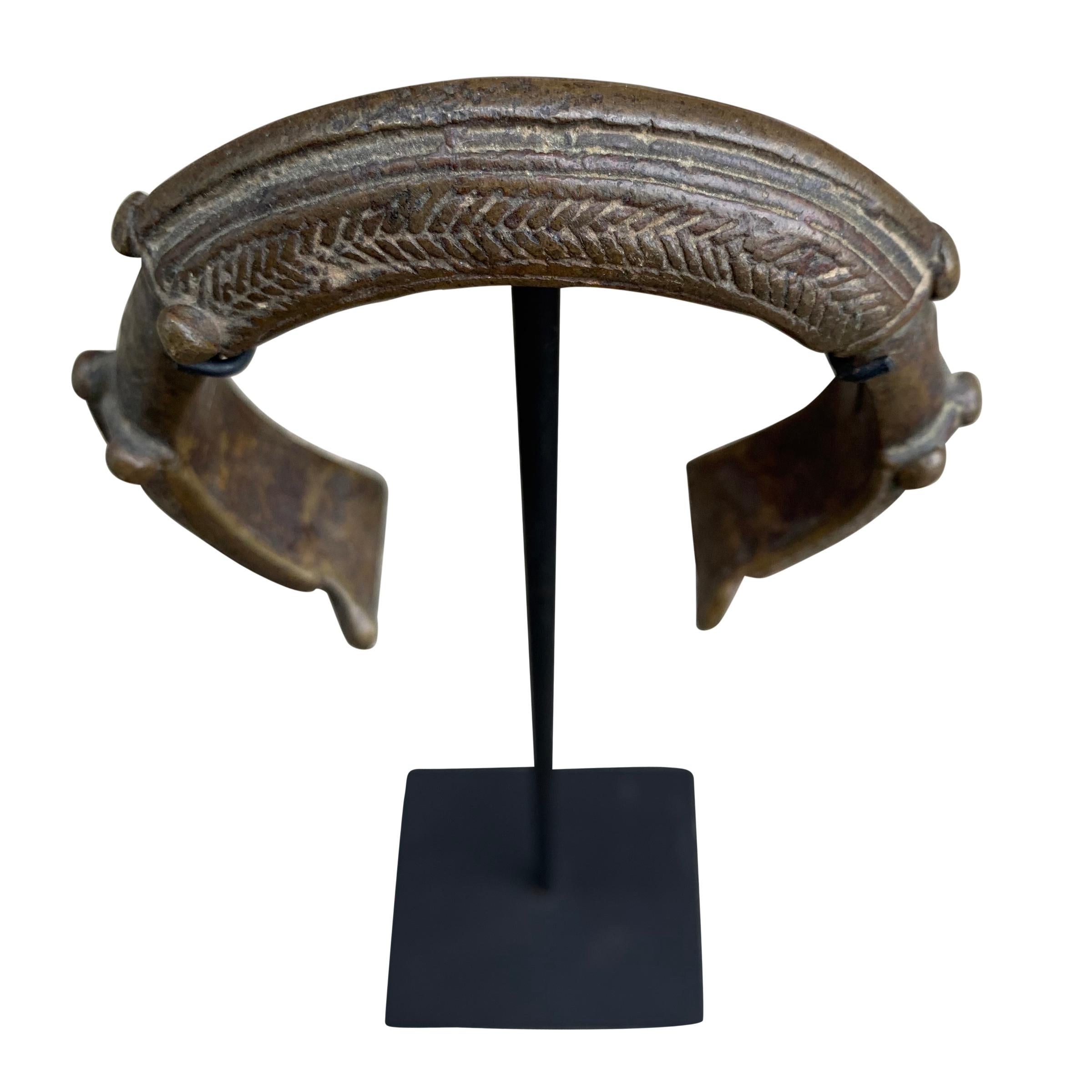 Set of West African Bronze Currency Bracelets on Stands 1
