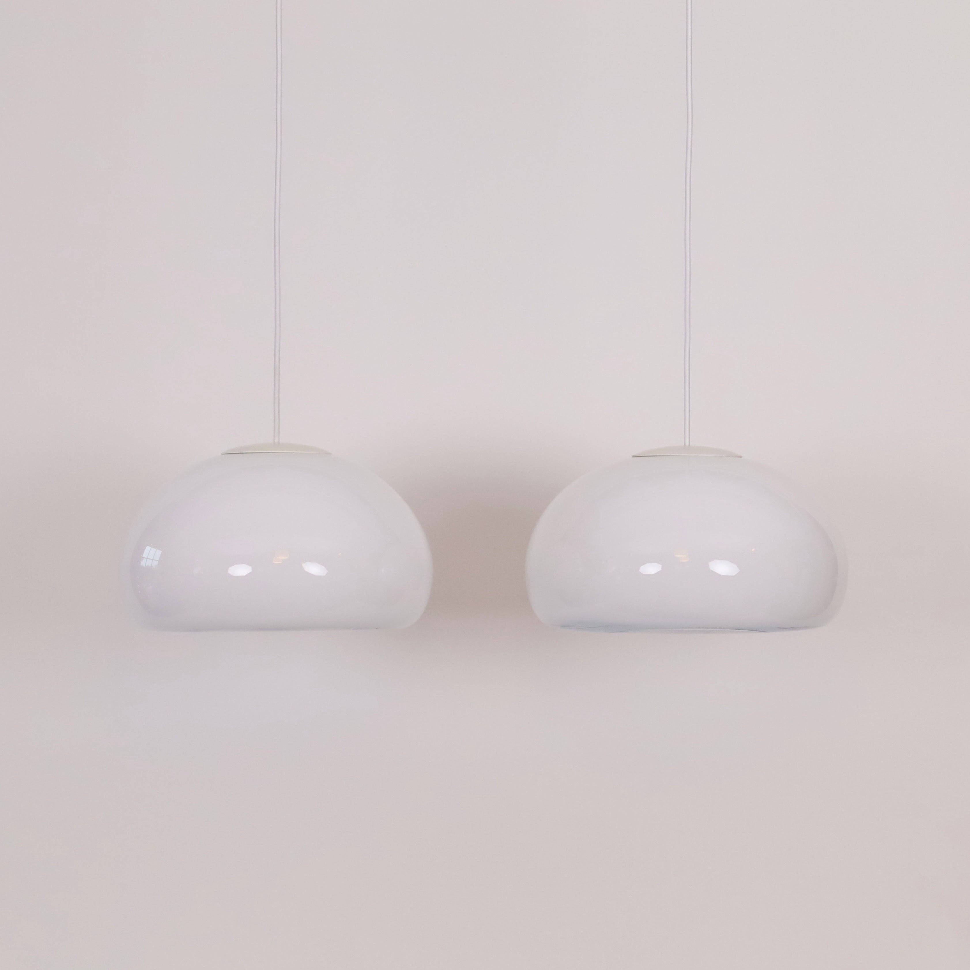 Ensemble de lampes suspendues en verre opale blanc, conçues par Per Lütken pour le danois Holmegaard Glasværk en 1983. C'est pour cette raison que ce style est appelé 