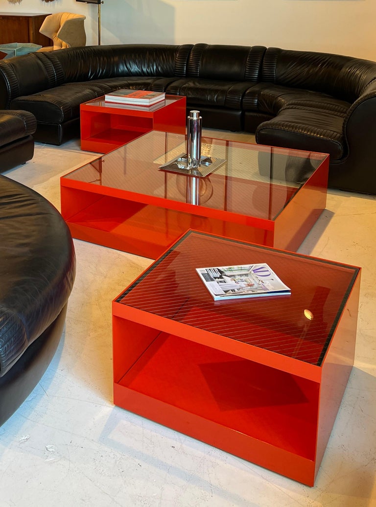 Rare set of three low rolling tables, coffee table model # 6048T and side tables model # 6022T designed by Joseph D'Urso 1981. The tables are in excellent condition in a rare factory red finish with the original wire safety glass tops. 

The price