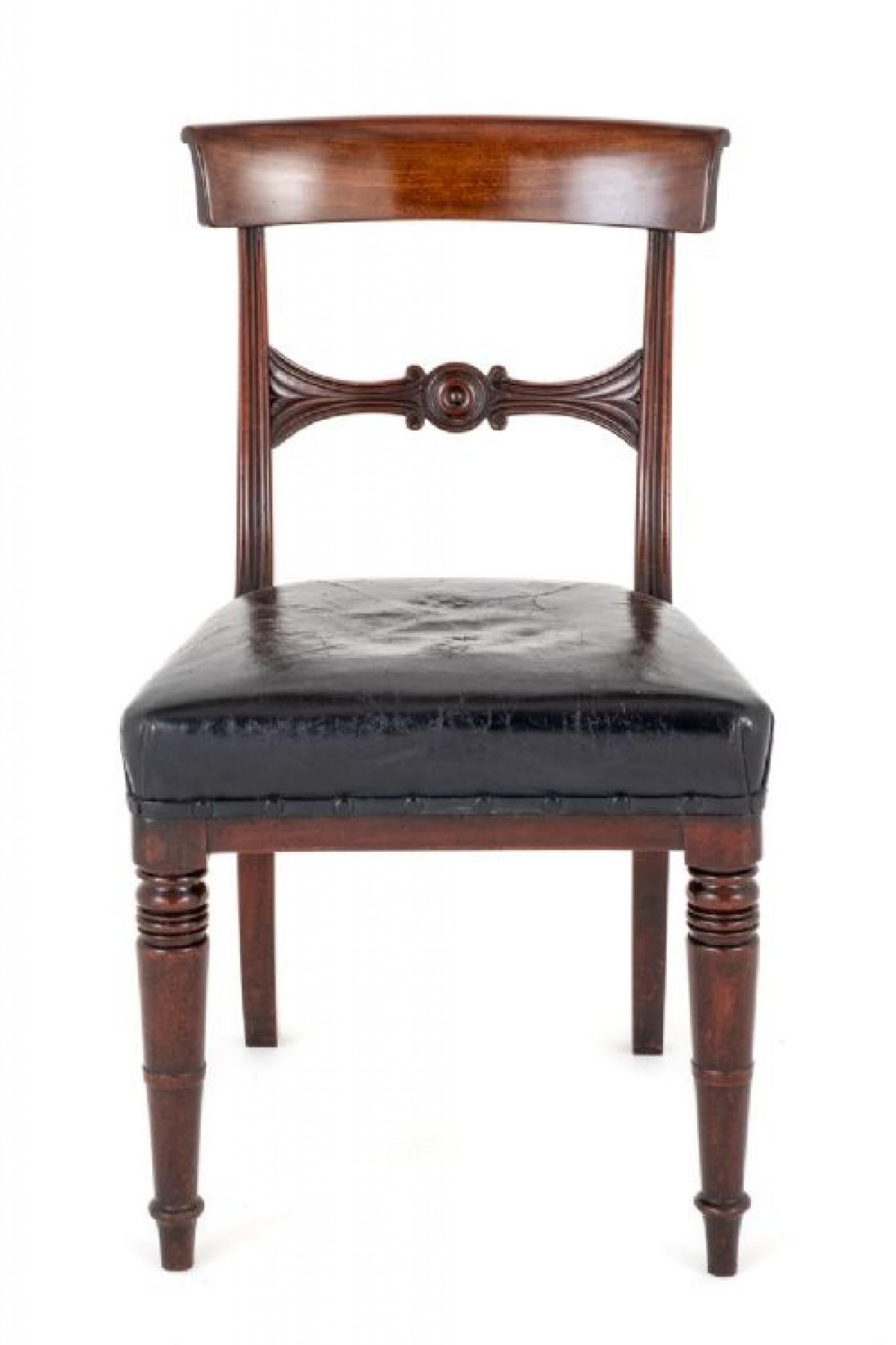 Set of 6 Regency Mahogany Dining Chairs.
Period Regency
The Chairs are Raised Upon Ring Turned Front Legs with Swept Back Legs.
The Chairs feature Leather Stuff Over Seats.
The Backs of the Chairs Having Fluted Uprights and a Carved and Turned