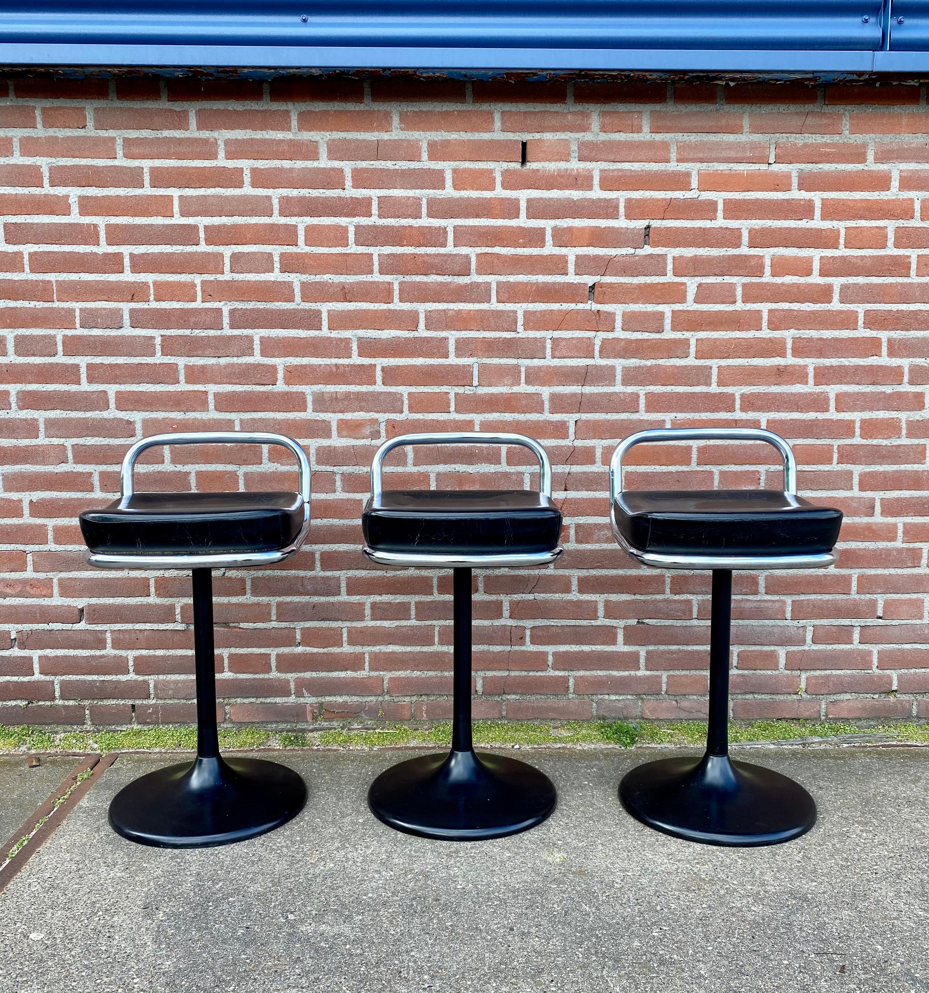 Set of three Postmodern stools featuring an artificial trumpet foot, with a leatherette seating and chromed tubular back. The stools were produced in Germany by Lush in the 1970s. They remain in good condition, with some signs of age and use. 