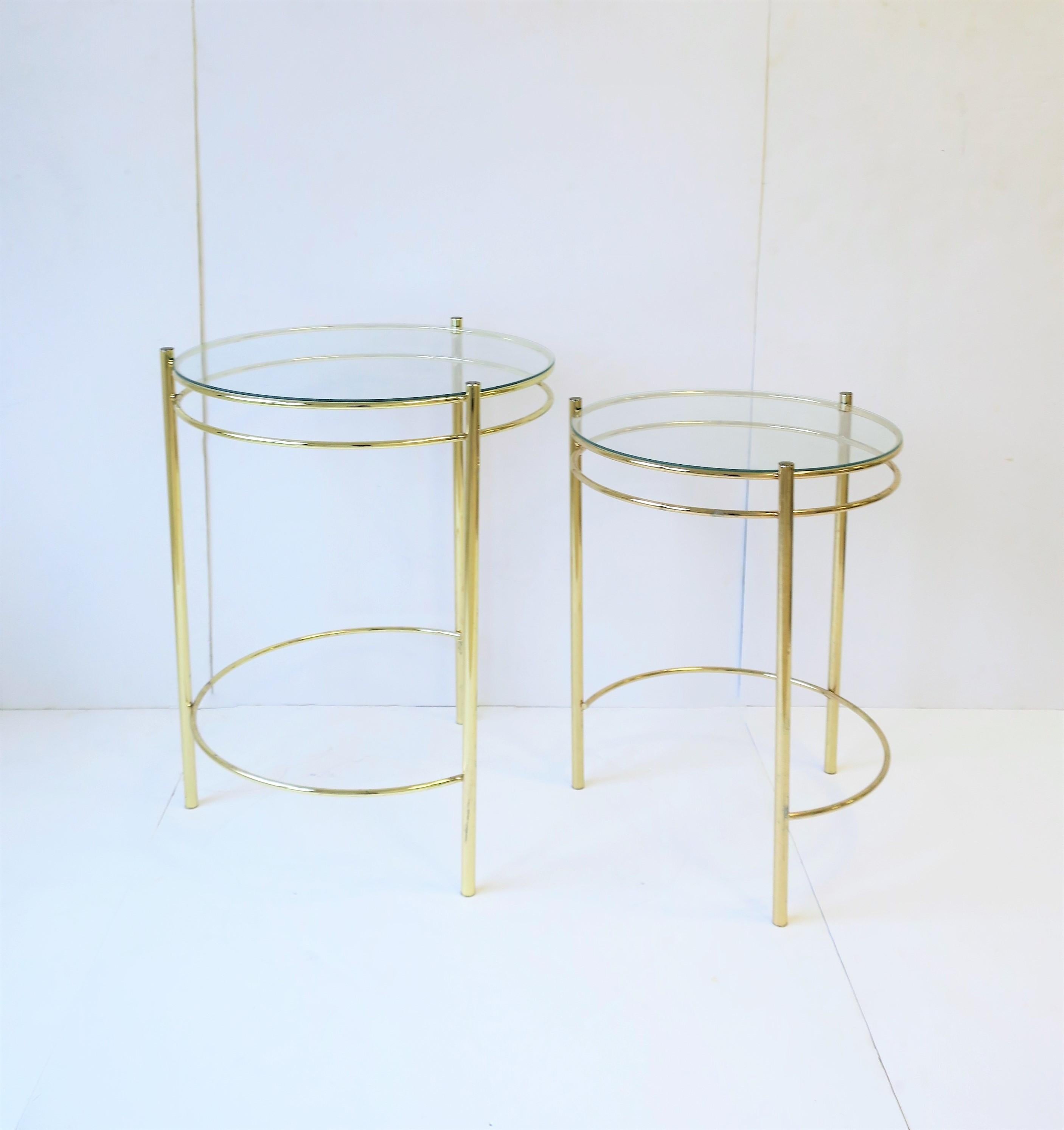 A set of round brass plated and glass top nesting end tables or side tables. Set can work well as an end table/side table combo. 

Tables measure:
Top: 22.5 in. height x 17.25 in. diameter
Nesting: 19.75 in. height x 15 in. diameter.