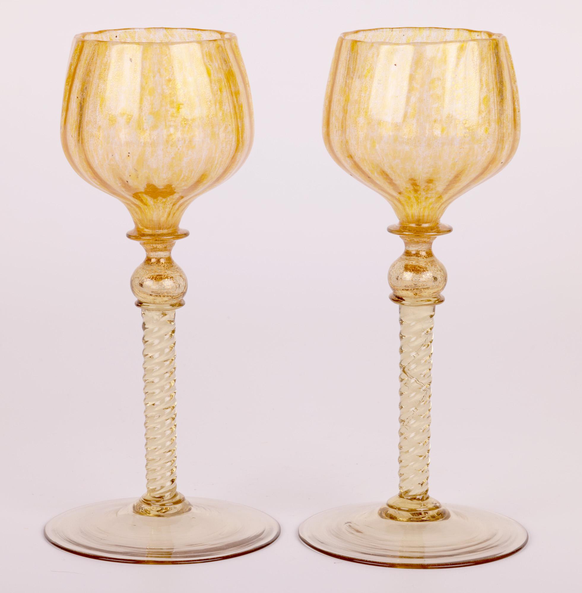 A stunning and unusual set six Venetian Murano wine glasses with bud shaped tops attributed to Antonio Salviati and dating from the early 20th century. The hand-blown glasses have round ribbed pattern bowls with yellow tinting and gold aventurine