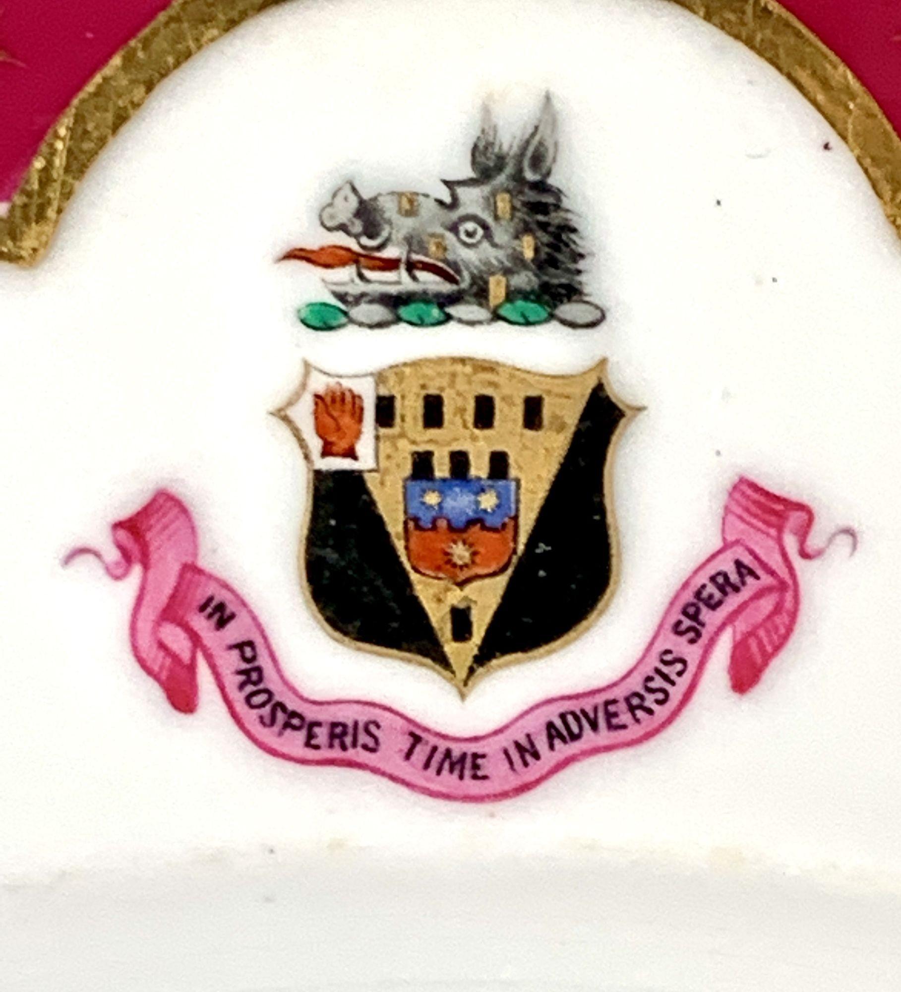 Copeland made this set of six excellent armorial soup dishes in England circa 1870.
The dishes feature deep burgundy-colored borders and a boar's head armorial with crest, escutcheon, and motto.
There are golden tassels where the border meets the