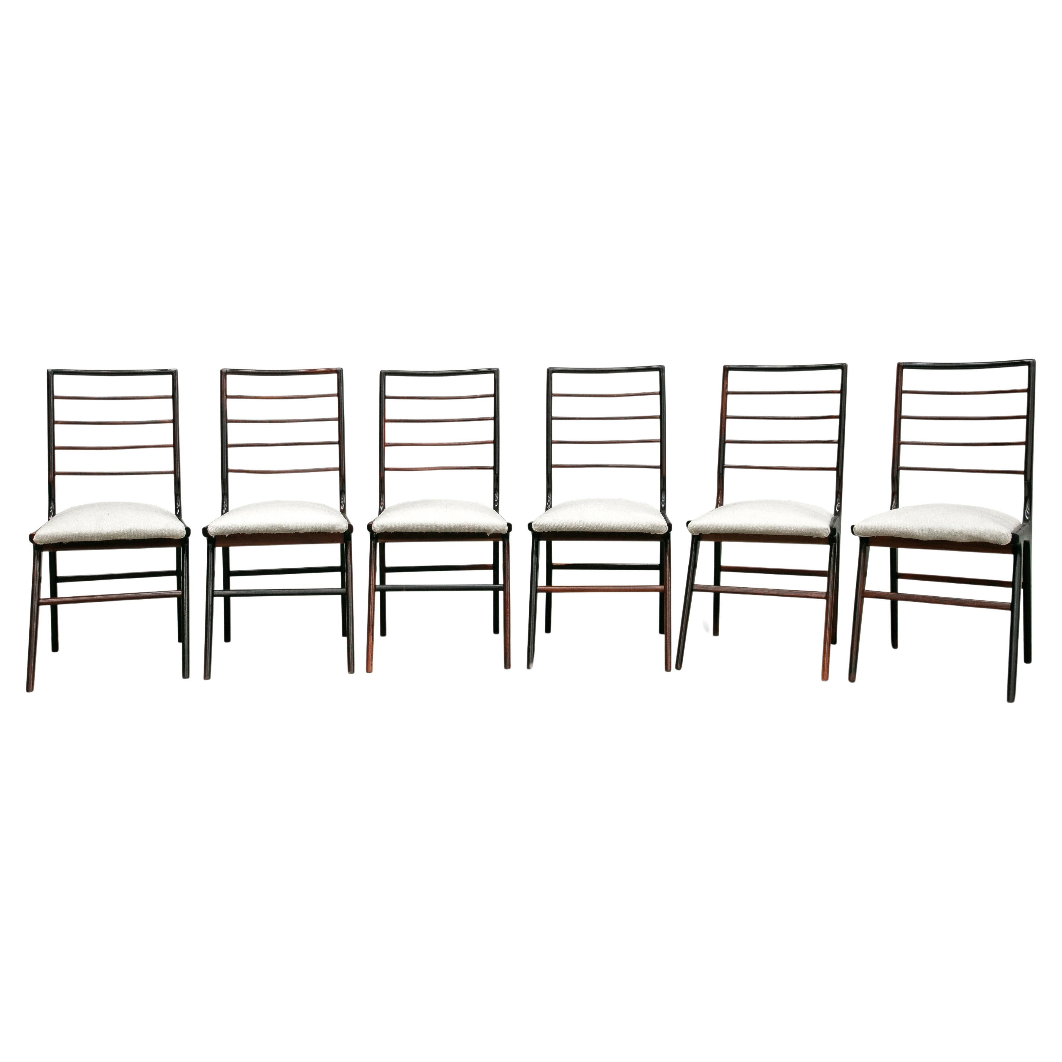 Available today, with domestic shipping in NYC metro area included, This Brazilian Modern Set of Six Dining Chairs in Hardwood and Fabric by Giuseppe Scapinelli, 1950s is nothing less than gorgeous!  

These chairs are made with a rosewood (also