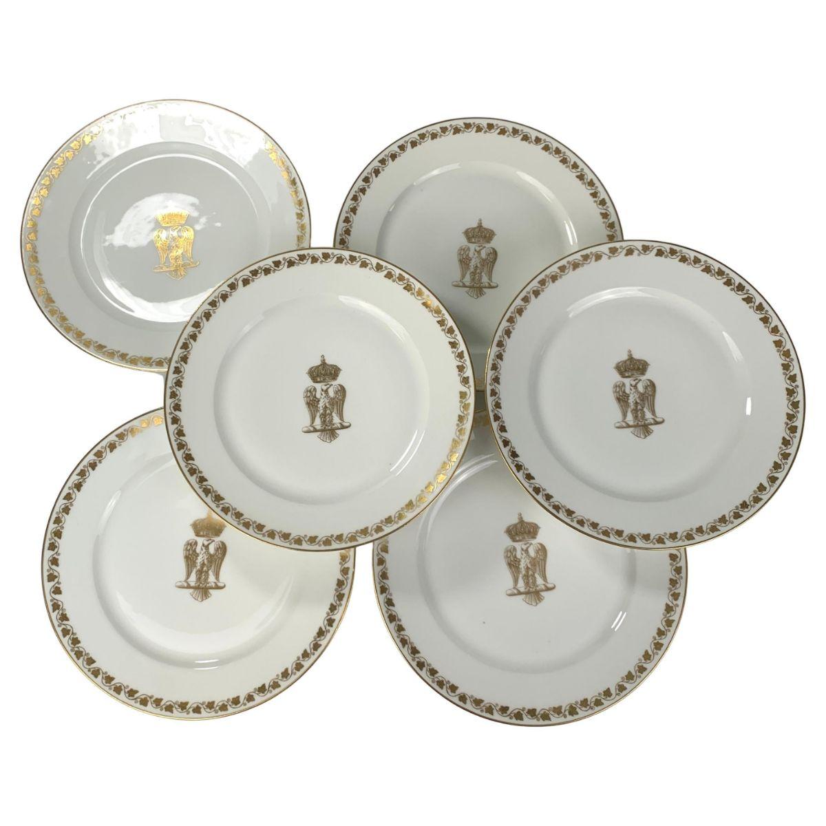 This set of six dinner plates features the Napoleonic Imperial Eagle below a crown. Made in the Sevres style in France in the 19th-century they are painted in gilt.
The borders are decorated with grape leaves on the vine.
The Imperial Eagle was
