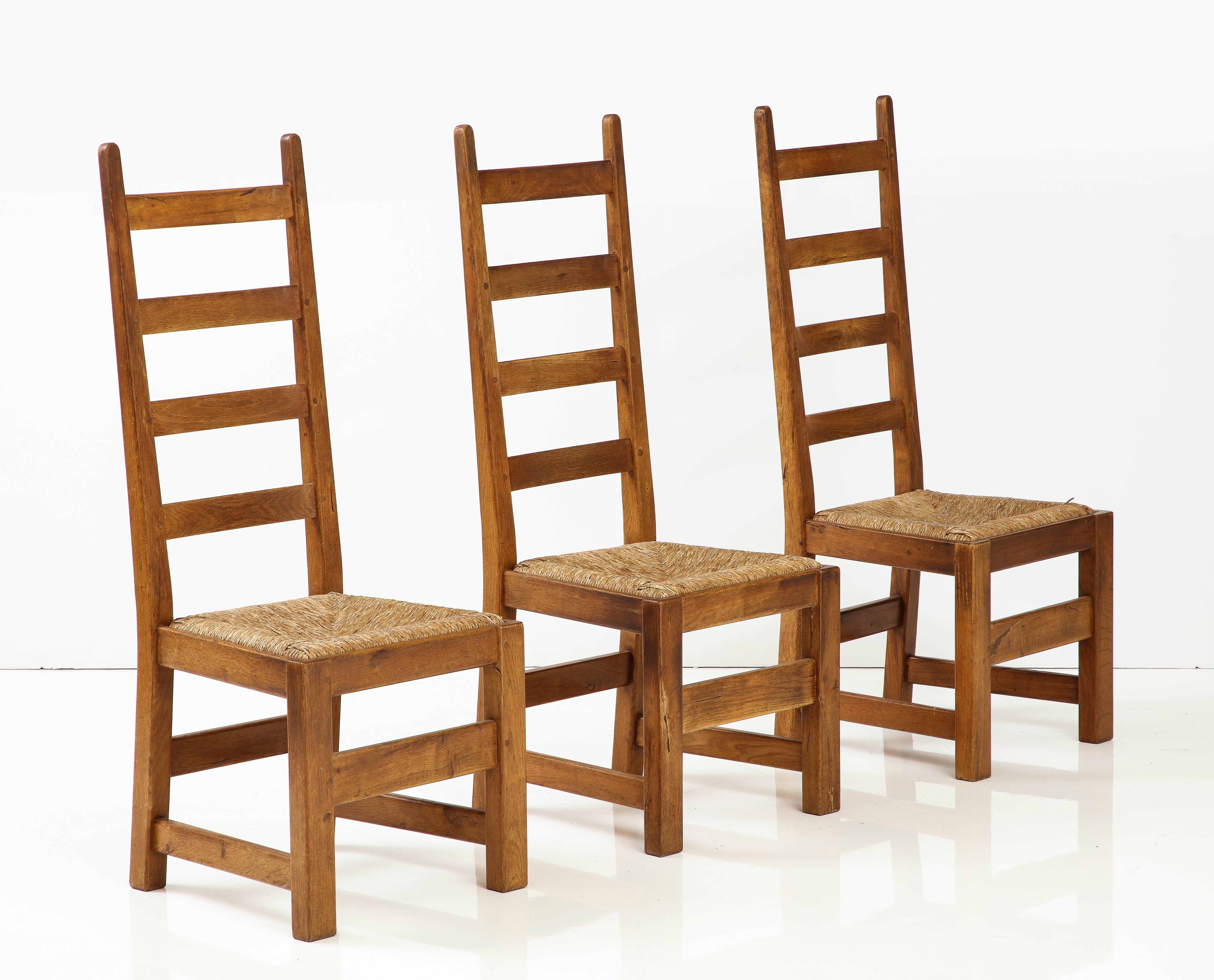 Français Ensemble de six chaises modernes rustiques à haut dossier en chêne et jonc, datant d'environ 1950, signées en vente