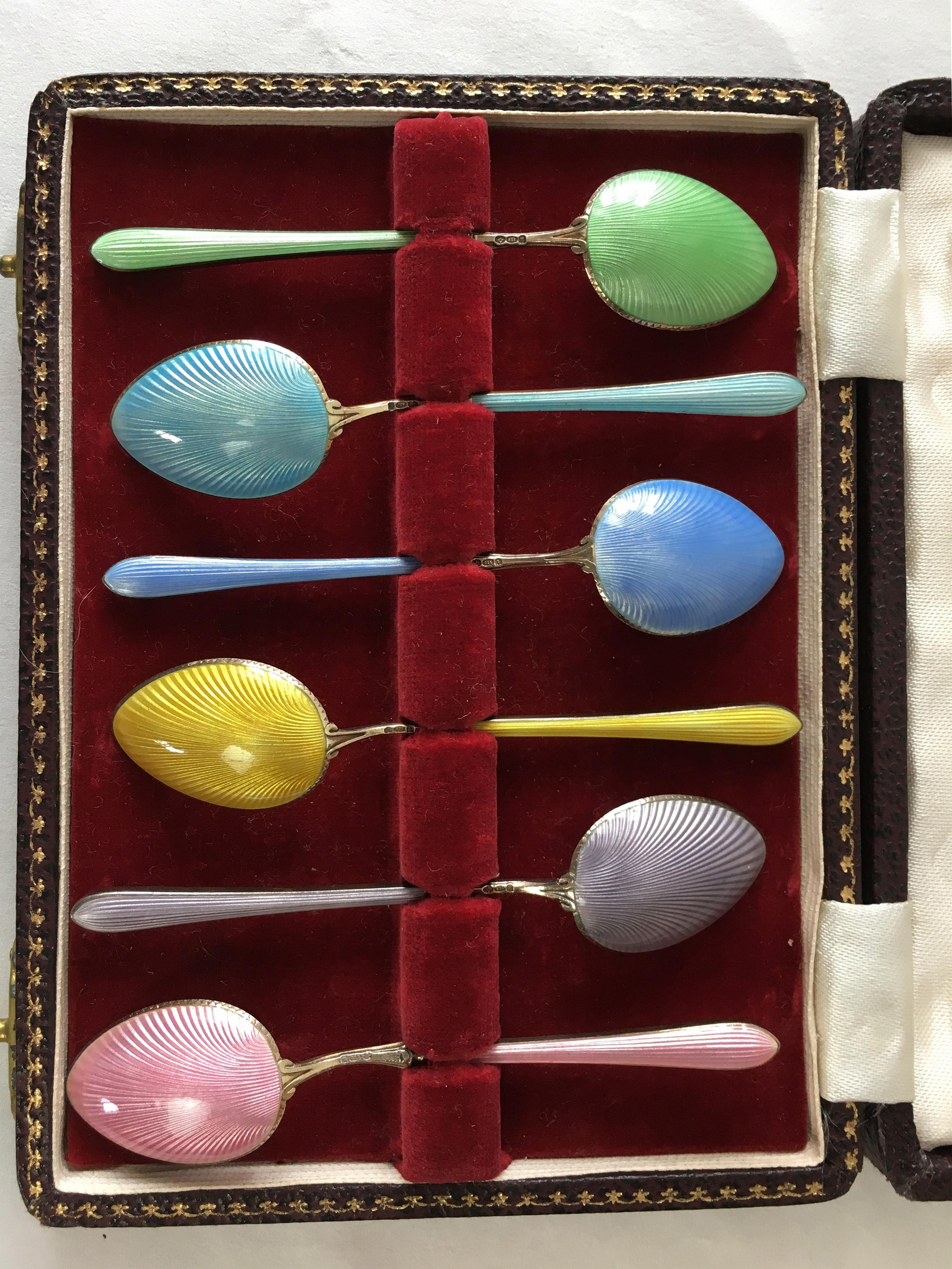Boxed set of six Norwegian colored guilloche enameled silver teaspoons with gold wash. The spoons in green, turquoise, blue, yellow, pale lavender and pink were probably made to celebrate Queen Elizabeth II’s Coronation in 1953.