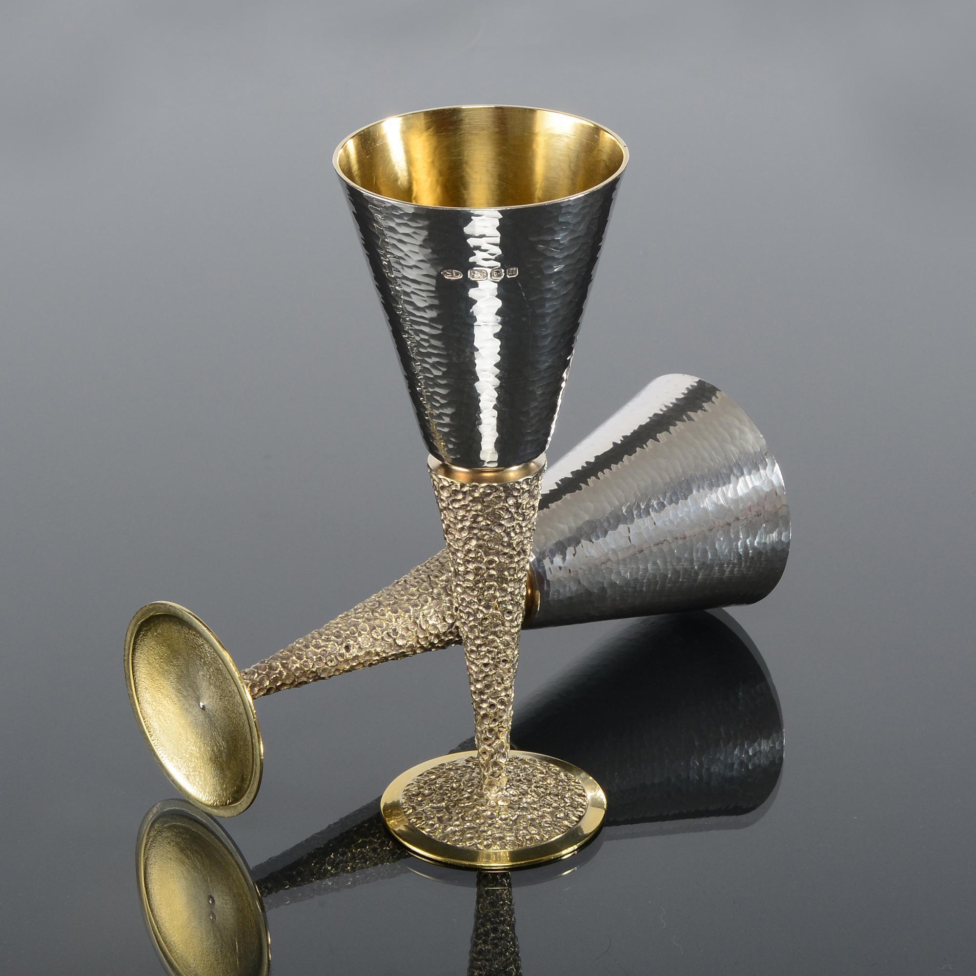 Set stylish mid-century Champagne flutes with tapering cone-shaped stems and circular bases decorated in a mottled pattern and gilded.  The hand-hammered bowls also have gilded interiors to create a most attractive and elegant appearance.  This is a