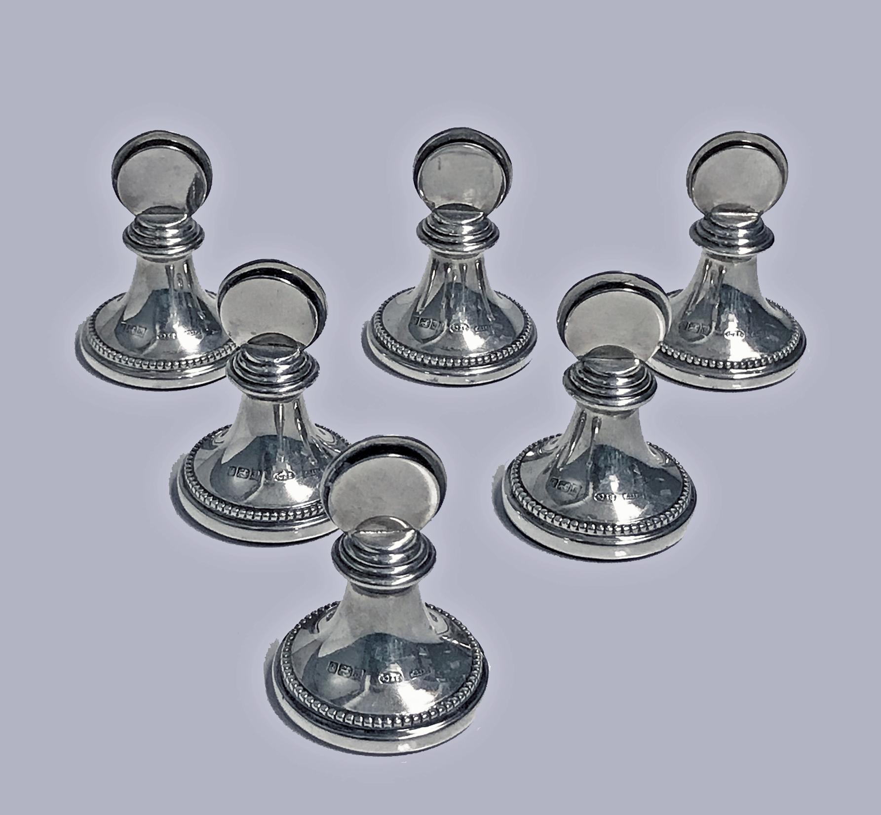Set of 6 silver menu place card holders Birmingham 1989, Broadway & Co, fitted box. The holders in the form of chess pawns. Heights: 2.25 inches. Base diameters: 1.5 inches. Green baize under bases for protection.