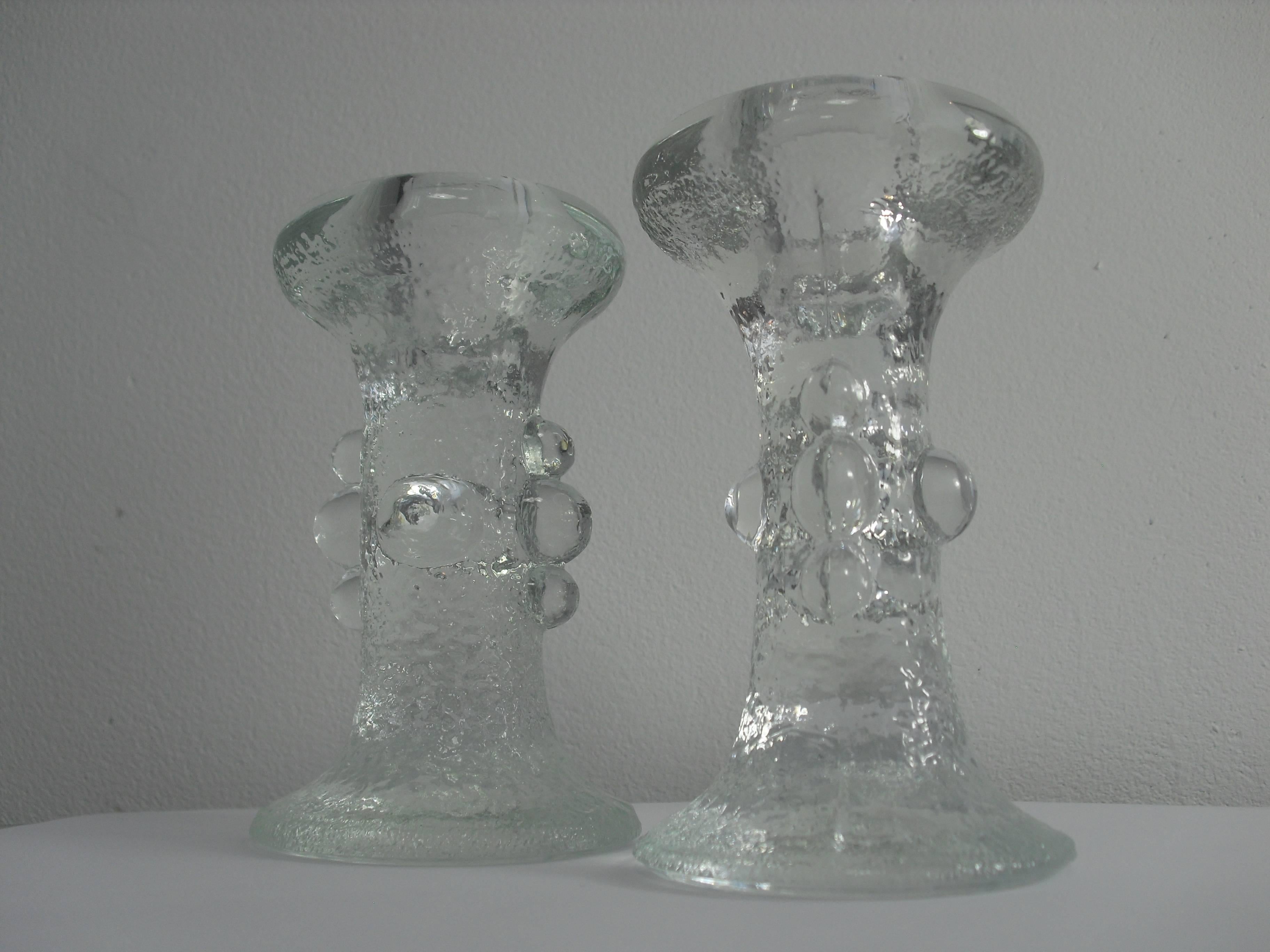 This set of two Swedish iced crystal glass candleholders are designed by Staffan Gellerstedt for Pukeberg Glasbruk during the 1970s.

Dimensions: height 12 cm x diameter 7 cm.
Condition: Perfect condition, no damage.


 
