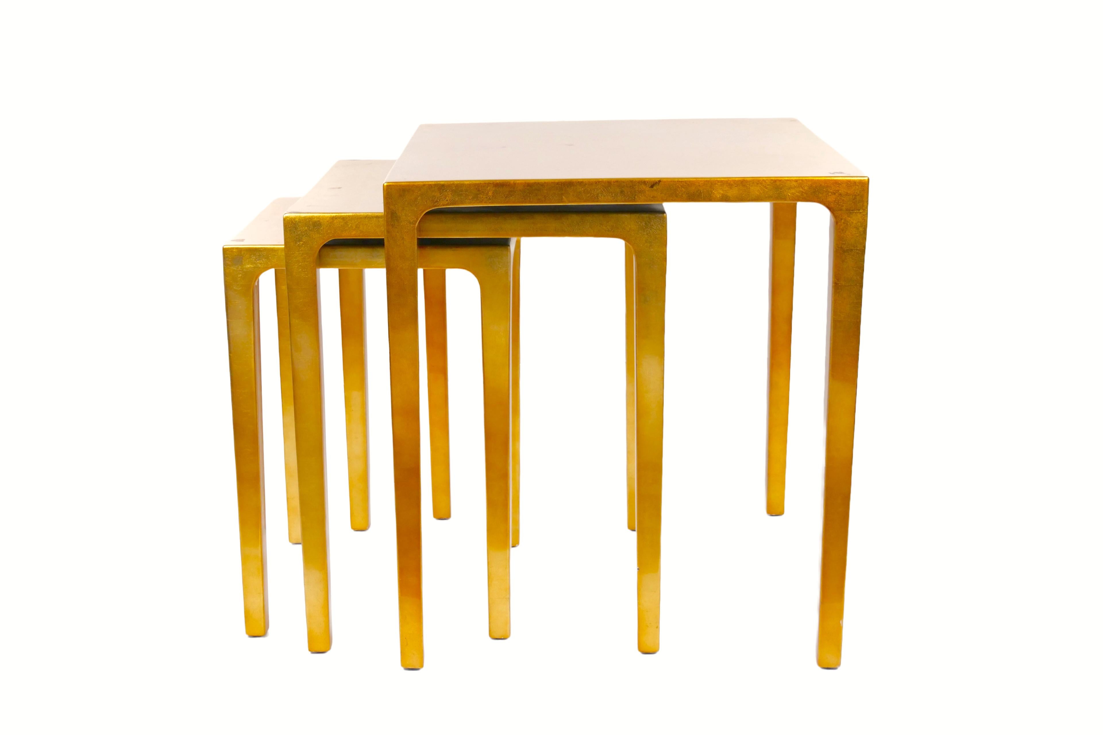 Enhance your living space with this exquisite set of three mid-century modern nesting side tables, Crafted with meticulous attention to detail. These stunning tables features a lustrous lacquered gold leaf finish that adds a touch of opulence to any