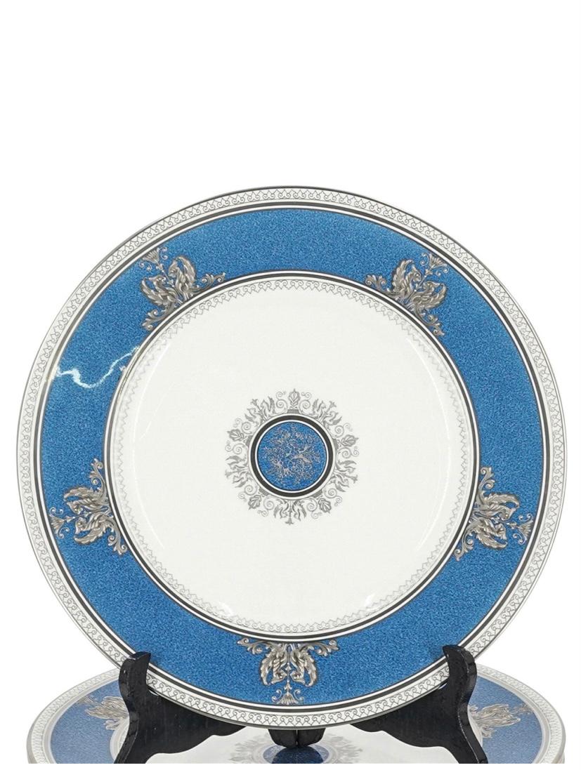 An elegant set of 12 dinner or presentation plates by Wedgwood, England Circa 1920's. This set has beautiful raised sterling silver accents and a center medallion. It's collar features a pretty powder blue coloring. They are in wonderful antique