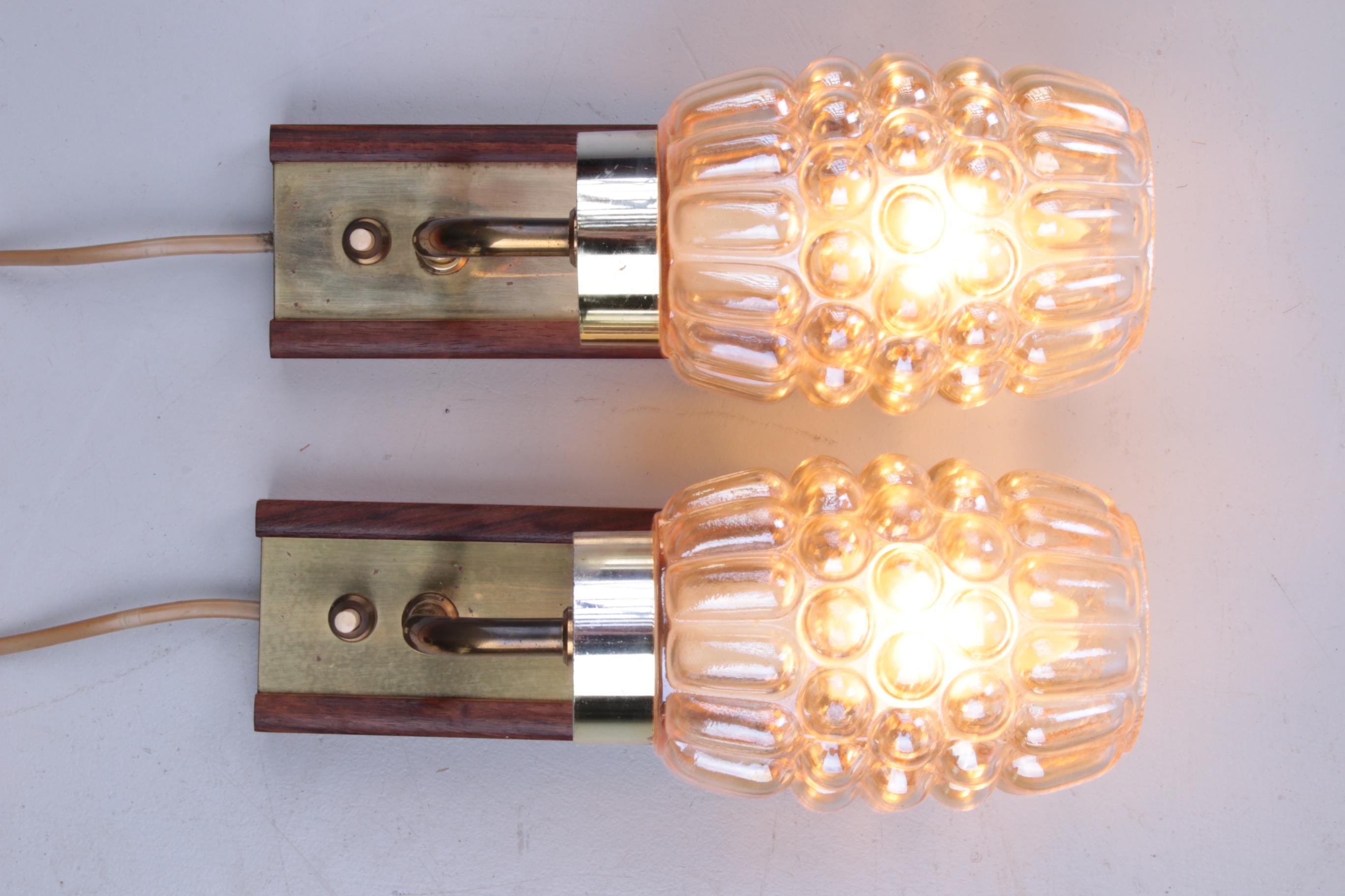 Set Wall lamps Danish teak with brass and glass.

Nice cute set of 2 wall lamps with glass and brass on a teak plate. It has a handy on-off button, so it can be used very handy as a bedside lamp.

Nice soft light comes through the glass.