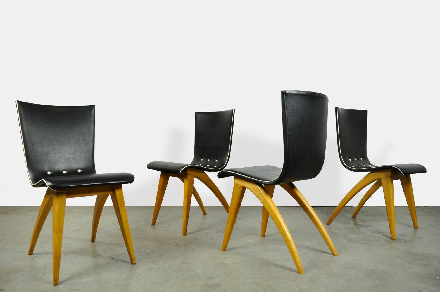 set of 4 uniquely designed dining table chairs designed by G.J. van Os and produced by van Os Culemborg, 1950s. The chairs have clear wooden legs, where the elegant rear legs together with the slightly flexible backrest determine the design of the