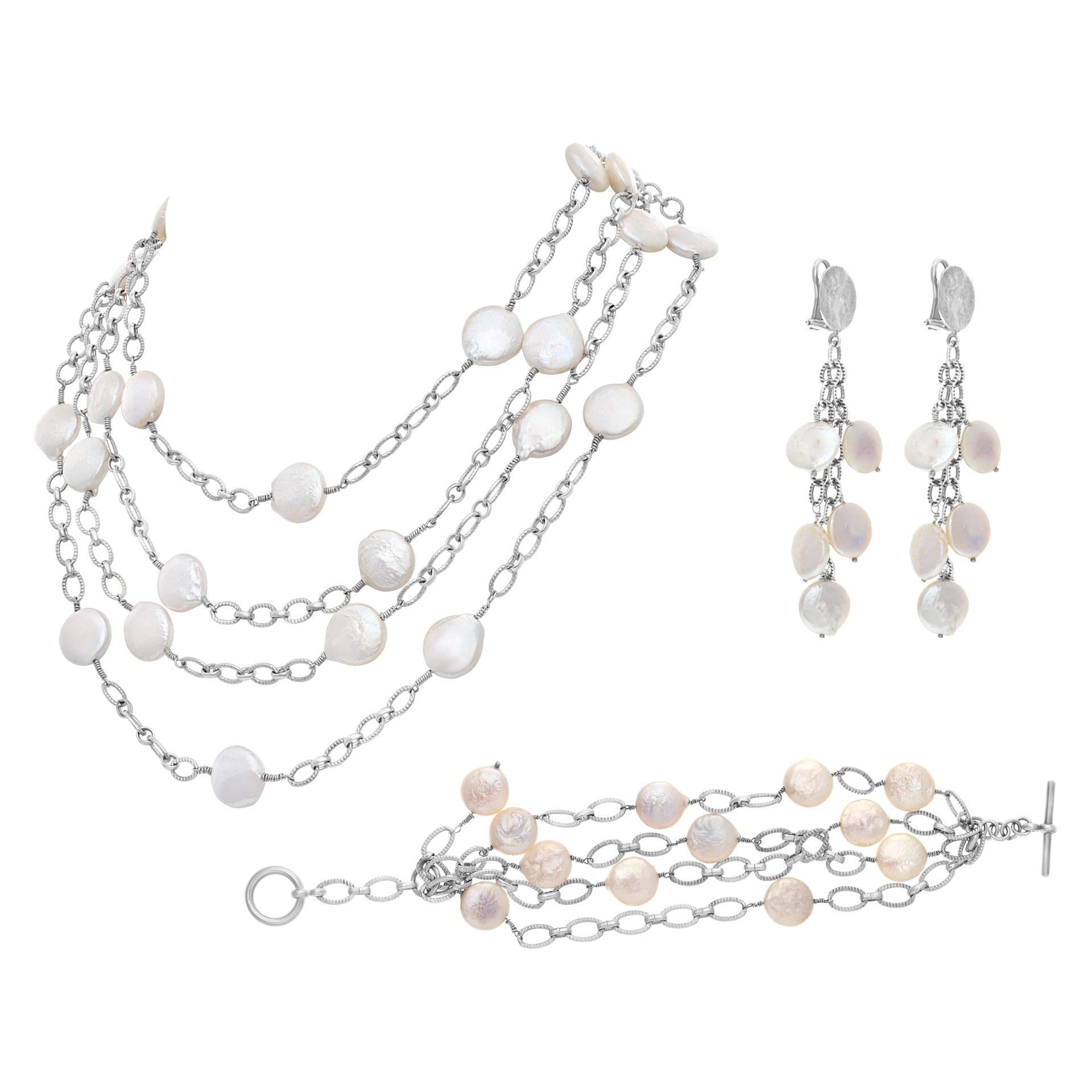 Set in 14k white gold with Mother of Pearl dots. Set includes: earrings, bracelet and necklace. Necklace is 18