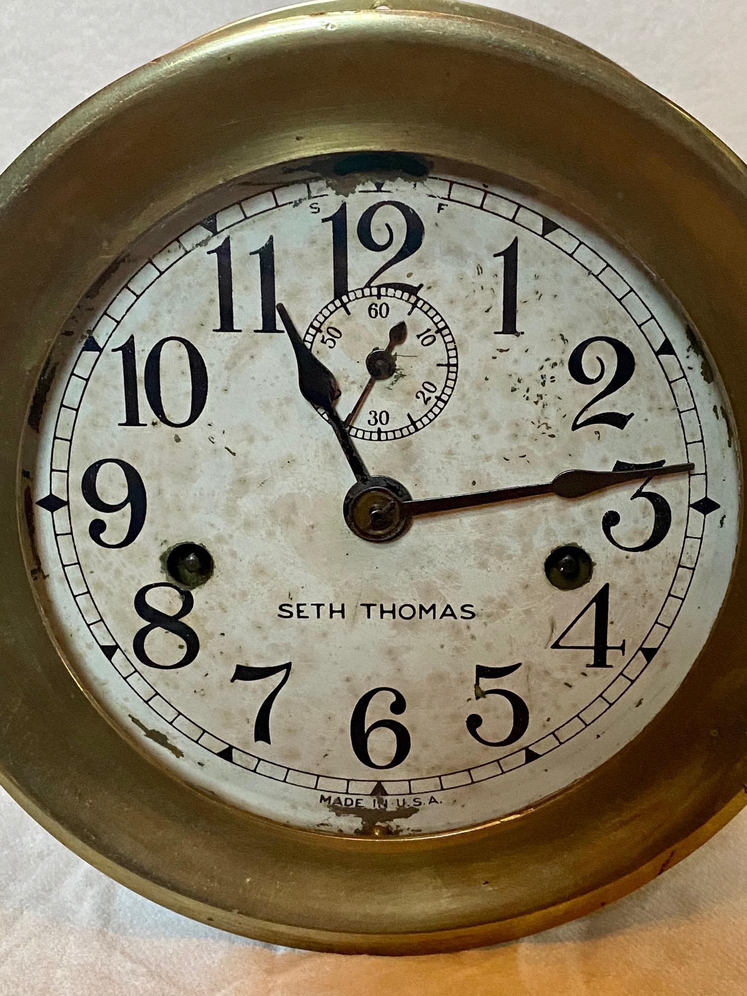 Early Seth Thomas brass ship's engine room clock, circa 1920, with No. 10 Lever Movement, double key wind time only clock, the 5 1/2 inch white painted metal dial having black Arabic numerals, hour and minute hands and a separate smaller sweep