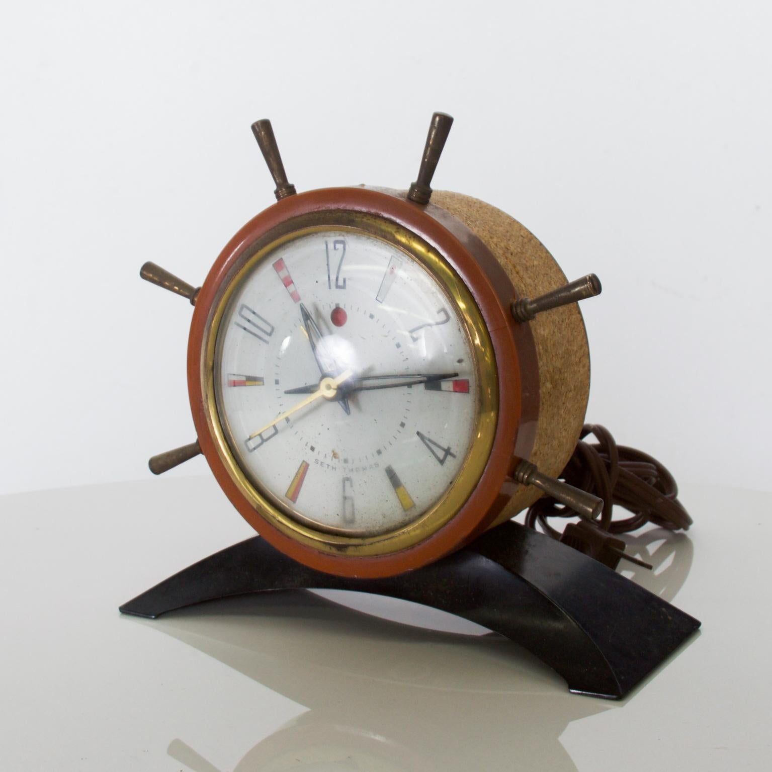 For your consideration: Seth Thomas nautical ship wheel rudder alarm clock, vintage electric, Mid-Century Modern nautical marine theme designed with metal, plastic and cork trim, USA, 1951

Dimensions: 5 3/4