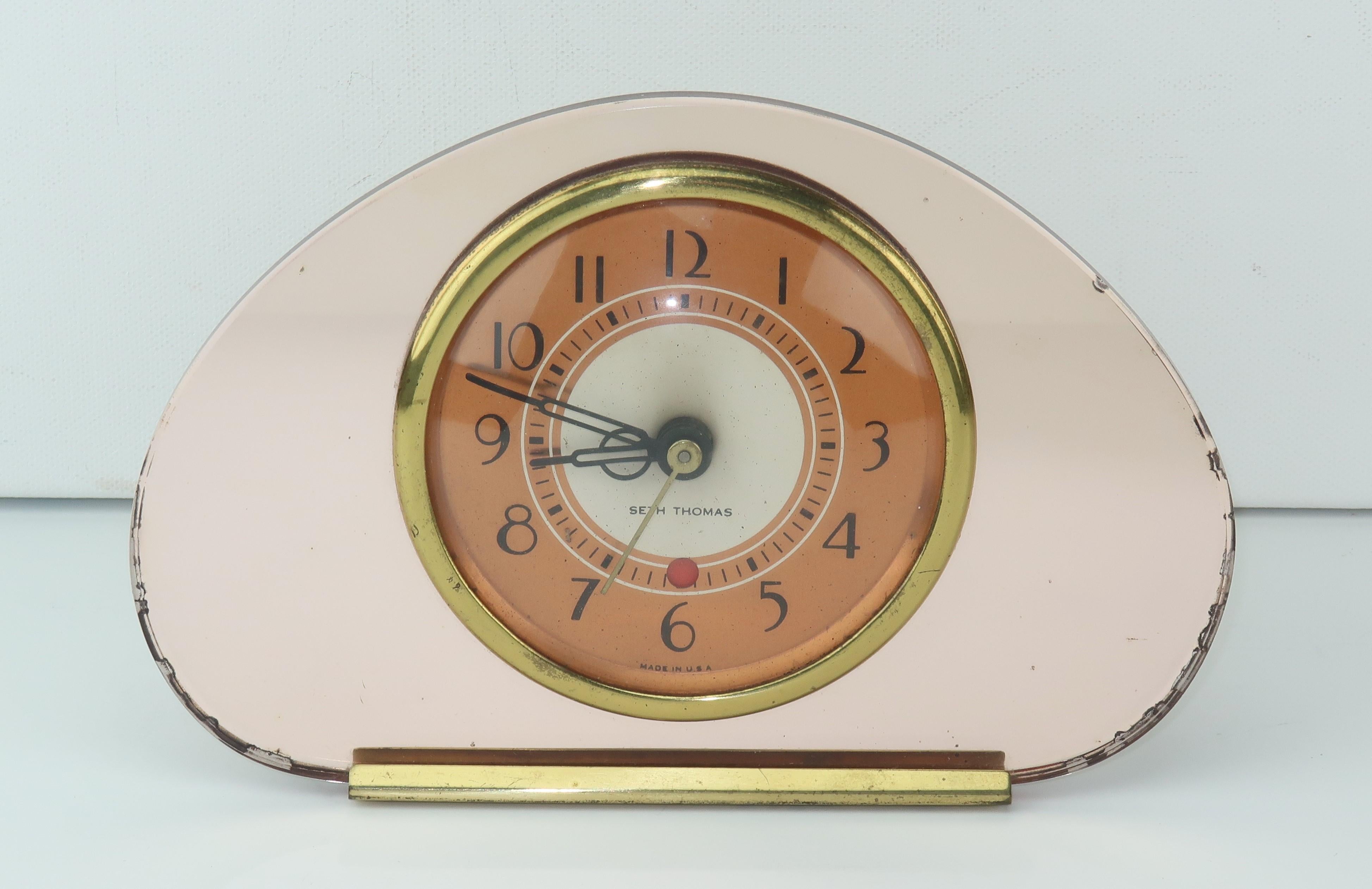 The epitome of Hollywood glam!  This Art Deco era Seth Thomas electric clock is mirrored for ultimate effect.  The peachy pink case is complimented by a copper dial accented with stylized black numbers and hands ... including second hand.  Designed
