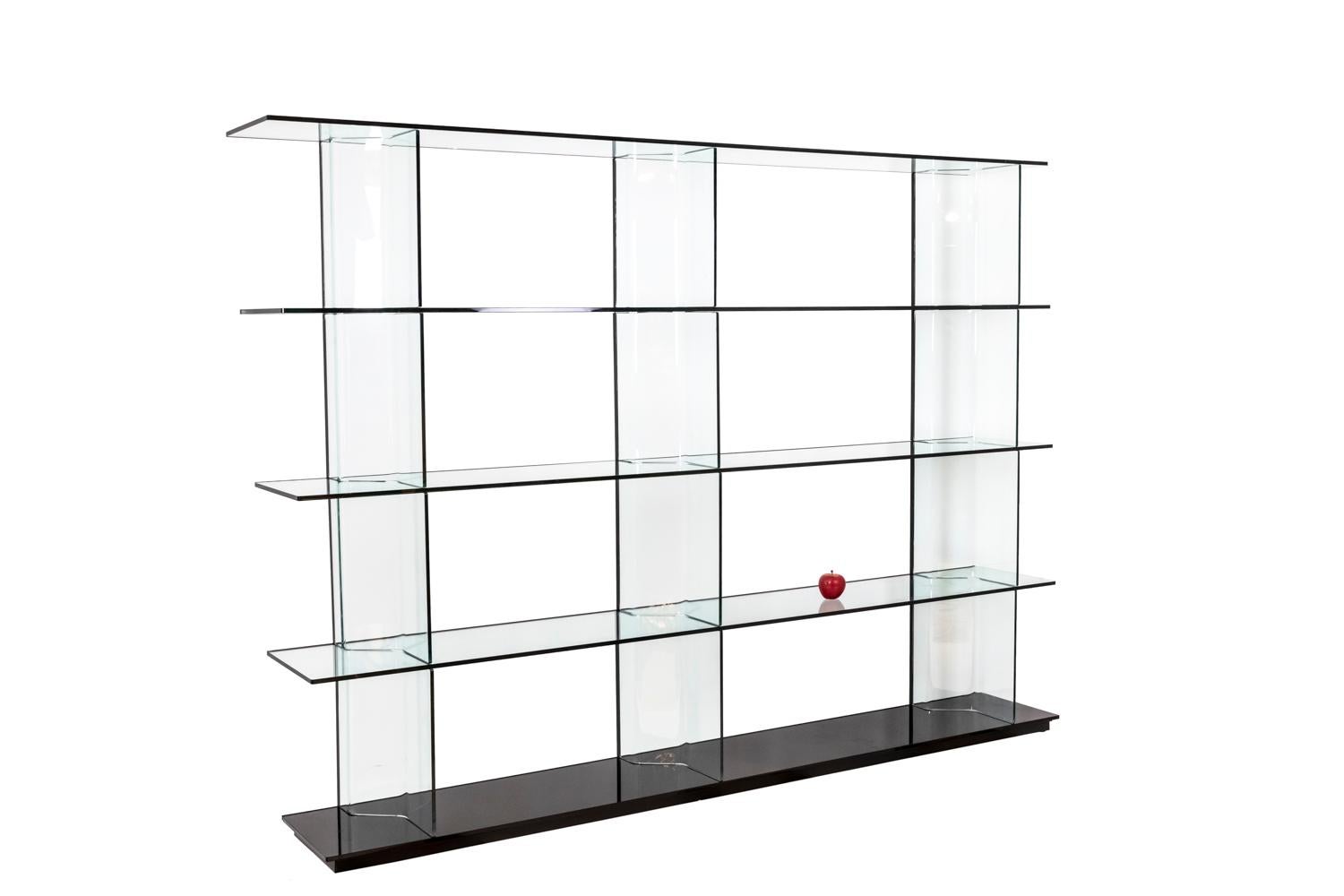 Bookcase composed of five selves in transparent glass. Inori model. System composed of modular elements in glass laying on a black rail in aluminum.

Work realized in the 1990's.

Setsu & Shinobu Ito are two Japanese architects and designers.