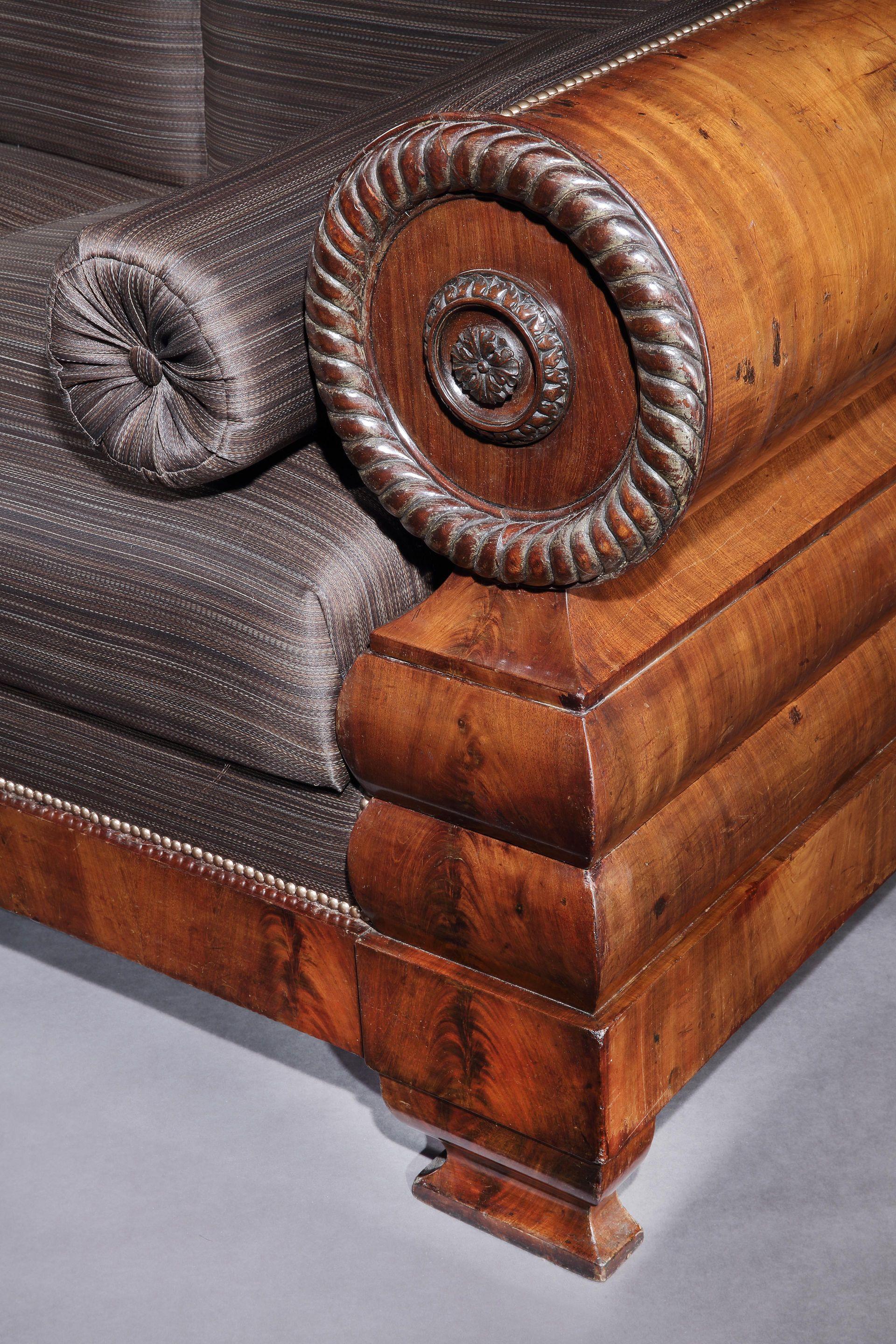 This handsome settee is in rare original condition retaining all the original timber and horsehair stuffings. The form is bold and fluid and the carved ornament very well executed. The carpenter has used veneers with exceptional graining which are a
