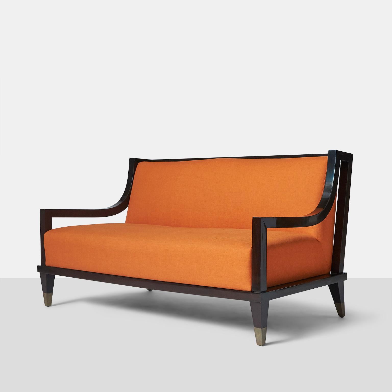 Settee by Mito Block Brothers.
A signature style settee by the Mito Block Brothers in Mexico City made in ebonized mahogany and square form brass caps on each leg. The back features a horizontal ladder back design with the upholstery being a