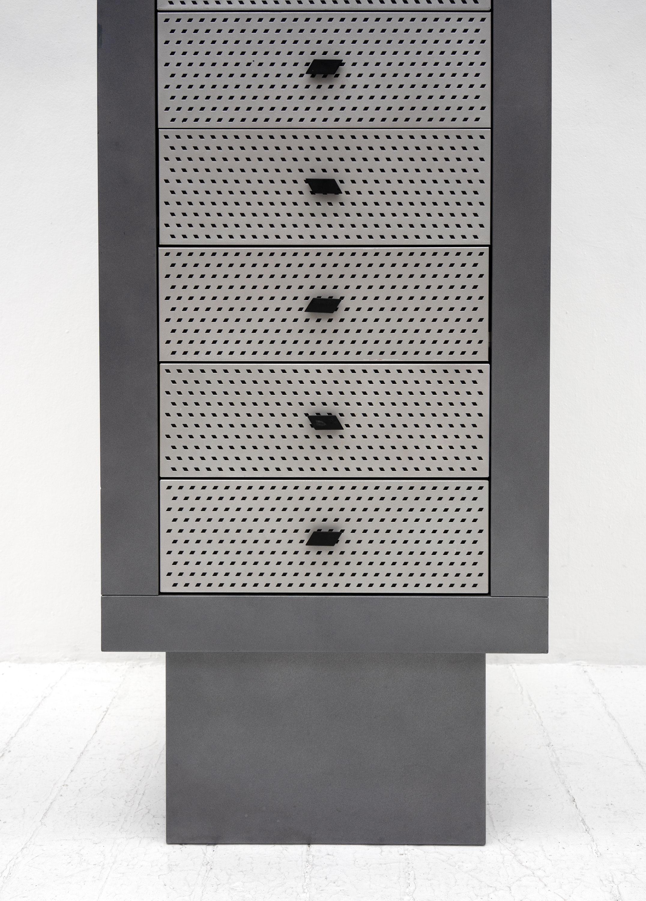 A 'Settimanale' chest of drawers designed by Matteo Thun and produced by Bieffeplast in small numbers in 1985. Composed from powder coated steel and featuring perforated drawer fronts and parallelogram shaped handles that alternate in direction.

A