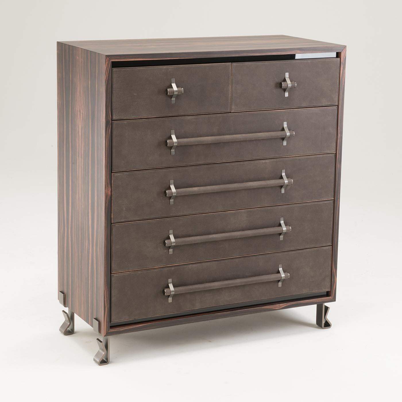 This chest of drawers is made from ebony wood that originated in Madagascar. It features matte gray lacquered drawers, whose front is covered in genuine leather with ebony trim. The item also includes black parapan inserts and stainless steel