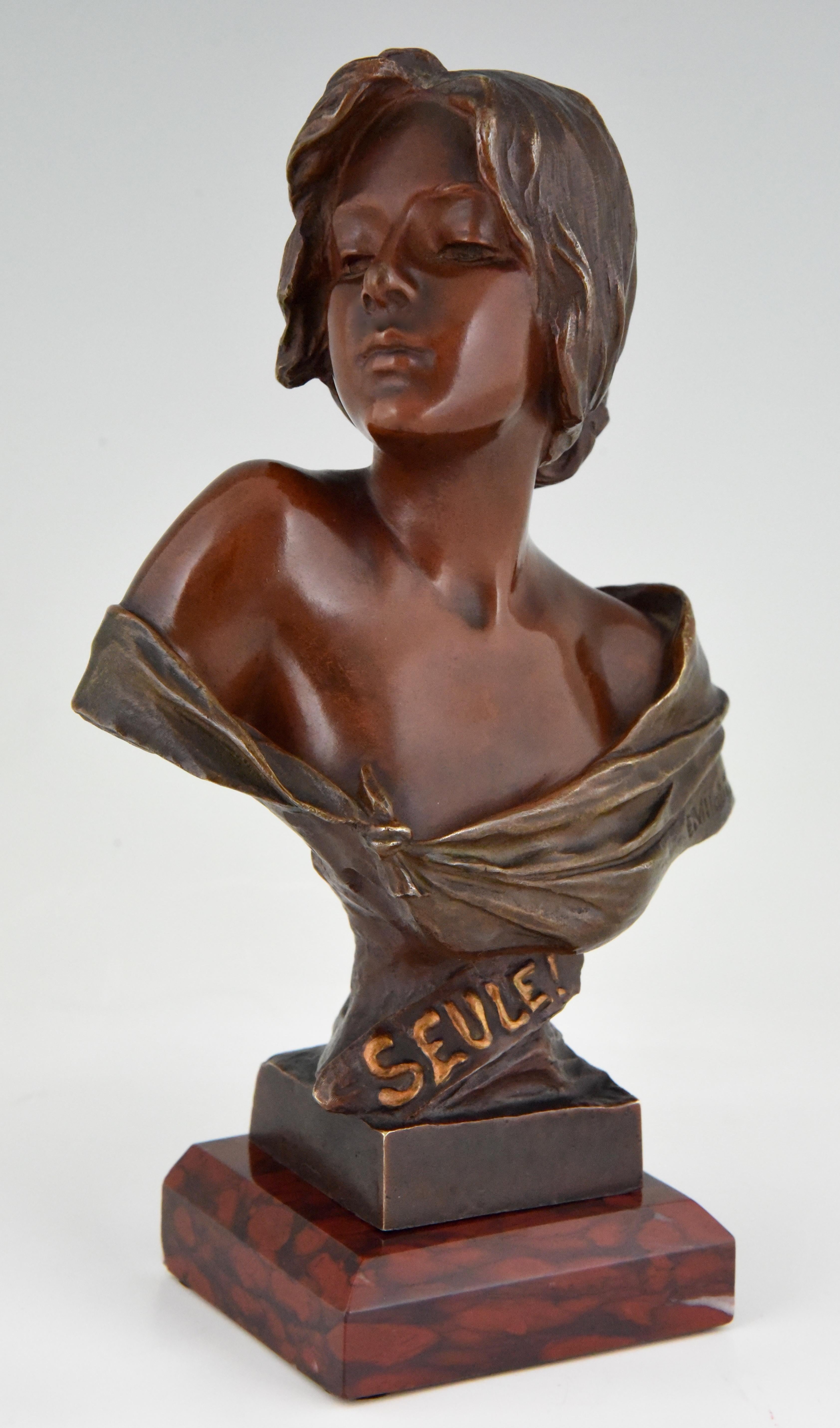 Beautiful Art Nouveau bronze bust of a woman titled Seule by the famous French sculptor Emmanuel Villanis, circa 1900. The bronze has a beautiful patina and stands on a red marble base. Signed and stamped with the Societé des Bronzes de Paris