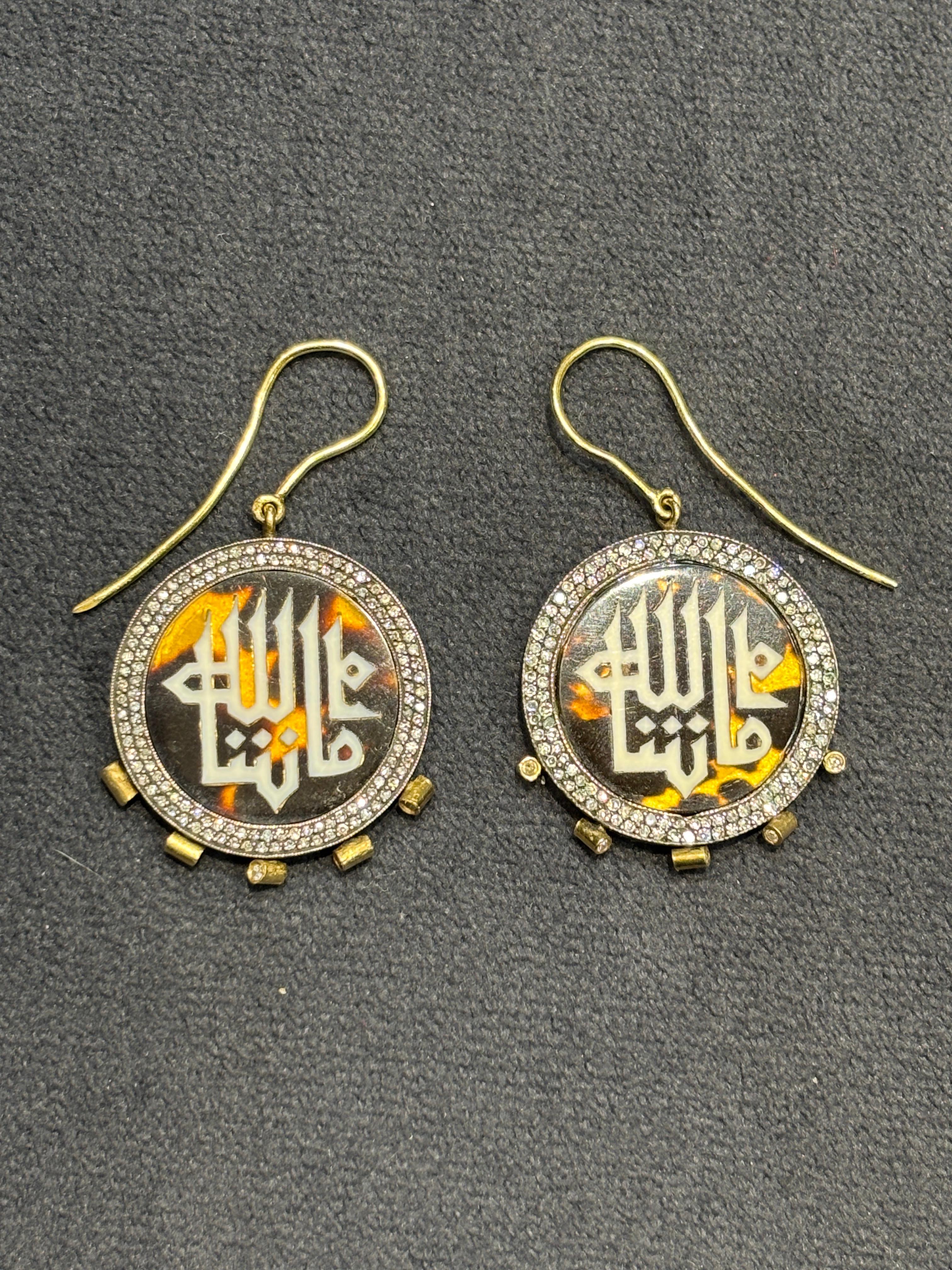 These striking earrings by Sevan Bıçakçı incorporate his signature use of 18k gold and silver adorned with diamonds. On one side of the earrings is written 'God Bless' while on the other side 'May God protect'.