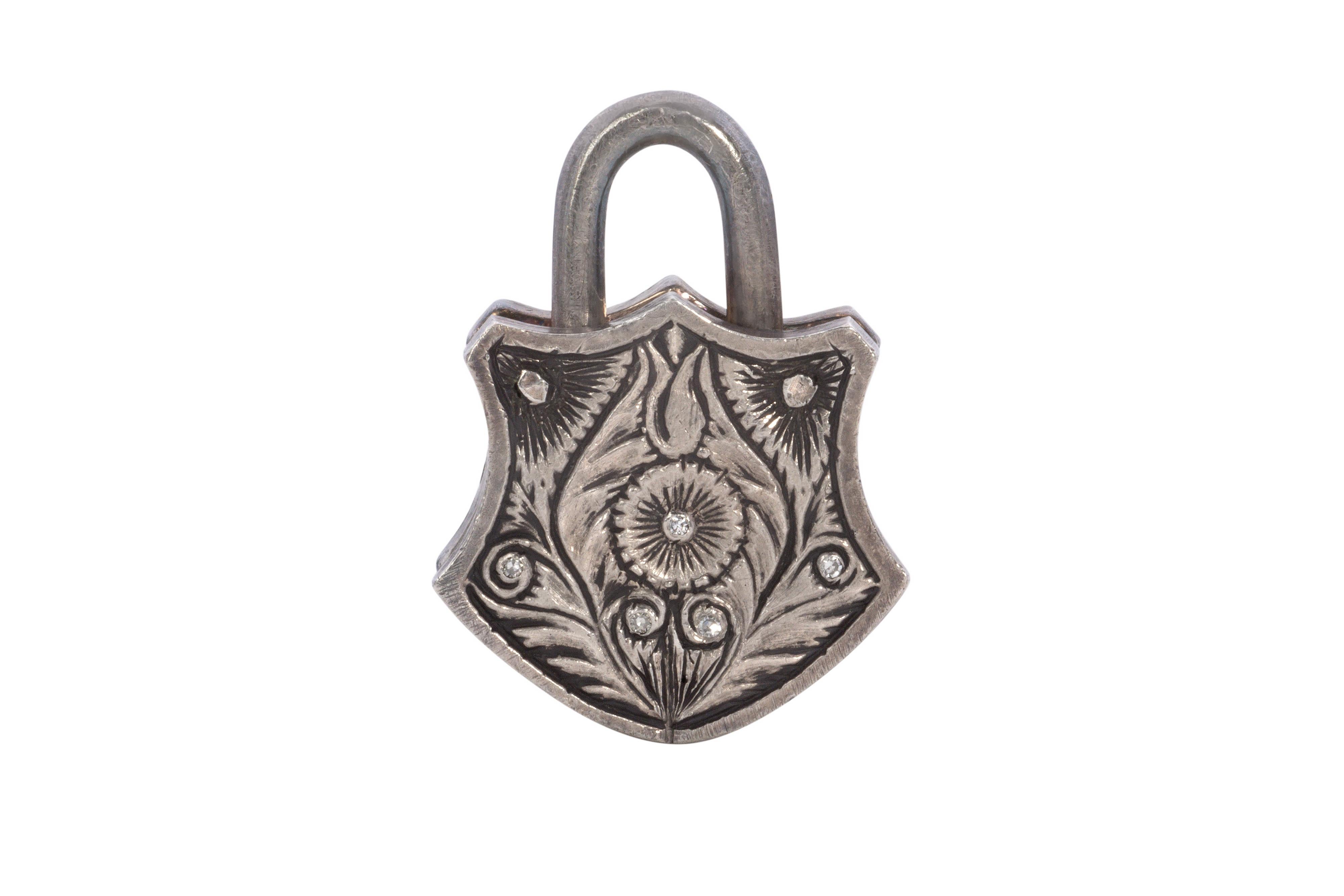 A diamond, 24 karat yellow gold, and sterling silver padlock pendant, by the renowned jeweler Sevan Biçakci, Turkey, 2011. Weighing 12.4 grams, this piece showcases 13 rose-cut diamonds and 22 single-cut near-colorless diamonds. Fully marked with