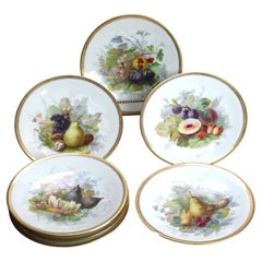 Sette antichi piatti in porcellana di Limoges dipinti a mano e dorati del 1880 ca.