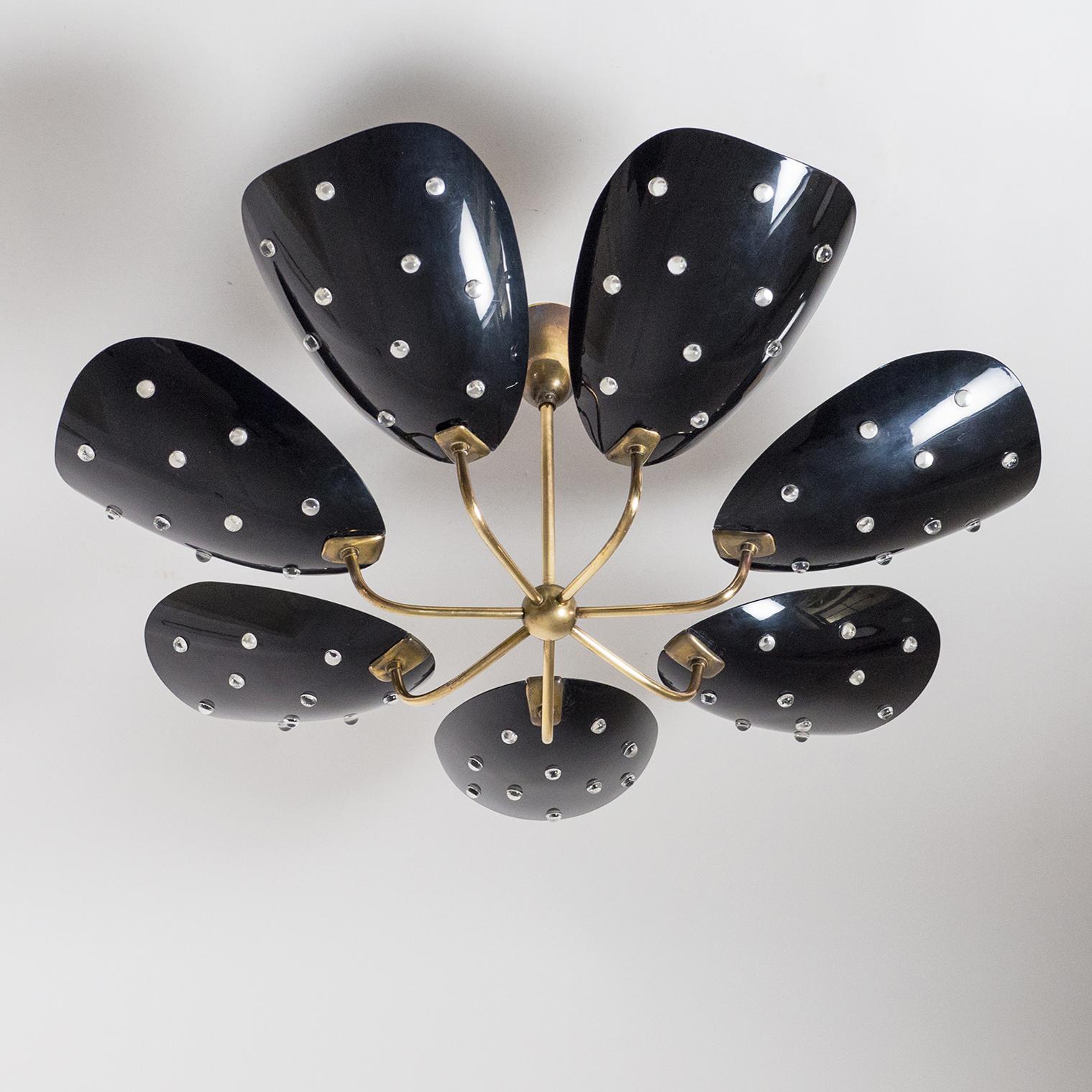 Rare midcentury seven-arm brass ceiling fixture with black acrylic shades. The organically shaped and curved shades have ten large perforations each which are filled with transparent acrylic 'beads'. Good original condition with patina. Each arm has