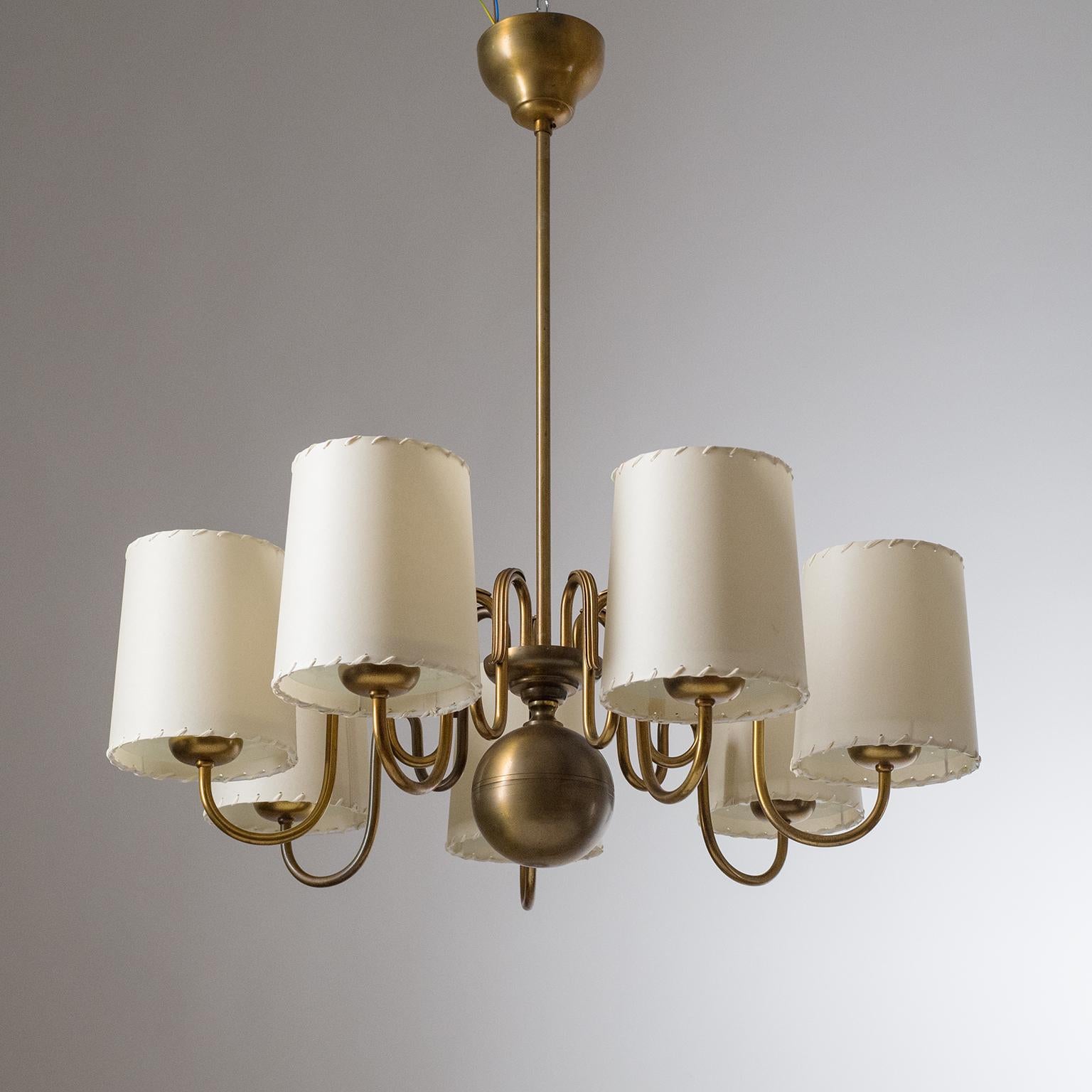 Rare Swedish brass chandelier by ASEA from the 1930, attributed to Hans Bergström. Seven brass arms, shaped in a cascading waterfall, with beometric decorations. Each arm ends in a frosted glass disc upon which the new parchment shades are placed.