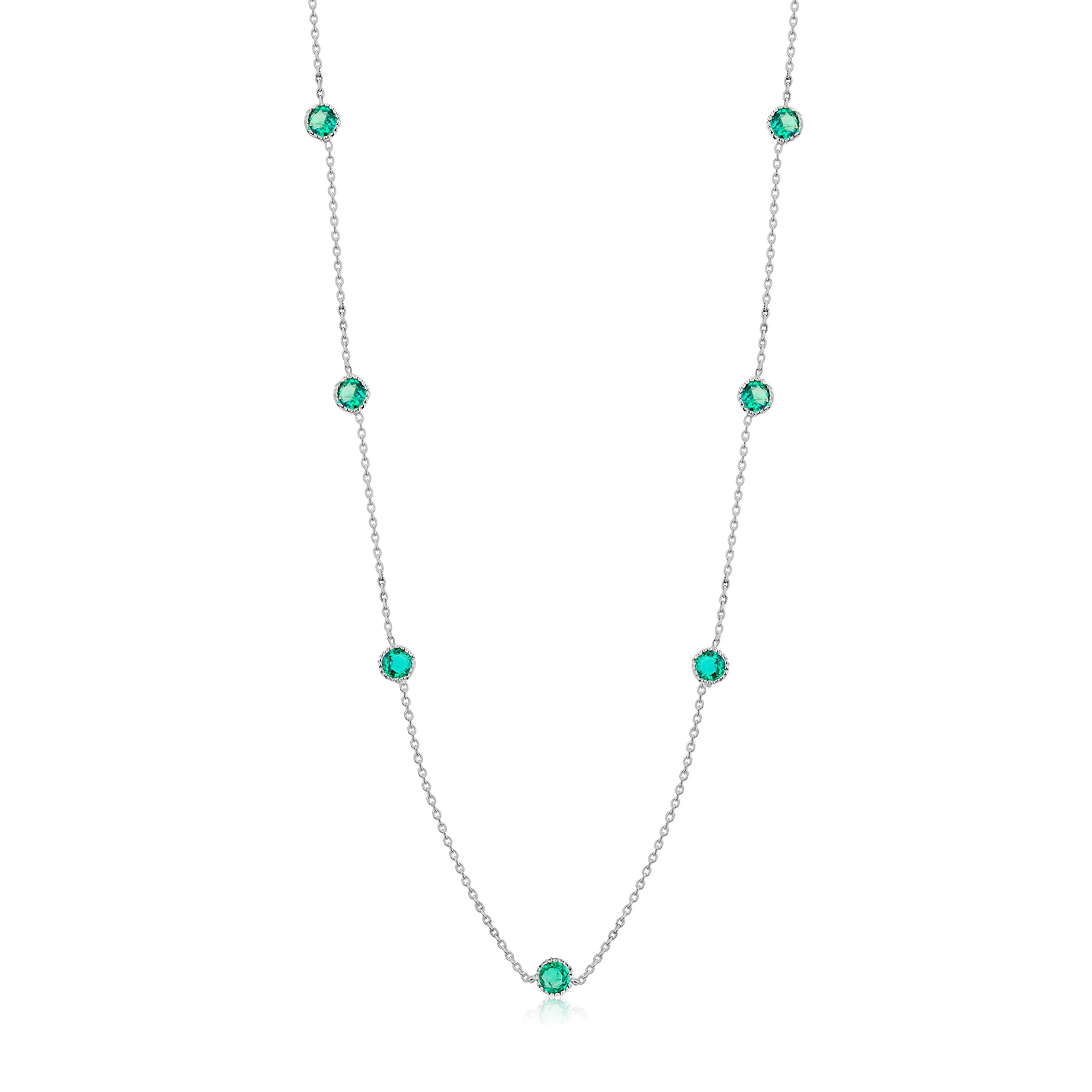 14 karat white gold seven-station bezel necklace 
Necklace measuring 16 inches long
Seven bezel-set round emeralds weigh 1.05 carats 
Round emeralds measuring 3 millimeters each
Each bezel is designed with a fine millgrain edge
Emerald hue tone