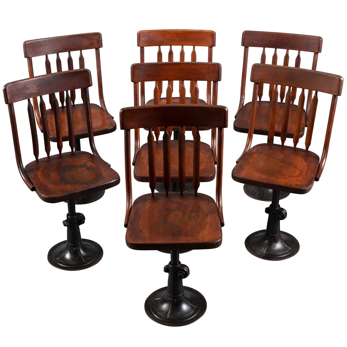 Seven Cast Iron and Wood Adjustable Height Chairs, circa 1895 For Sale