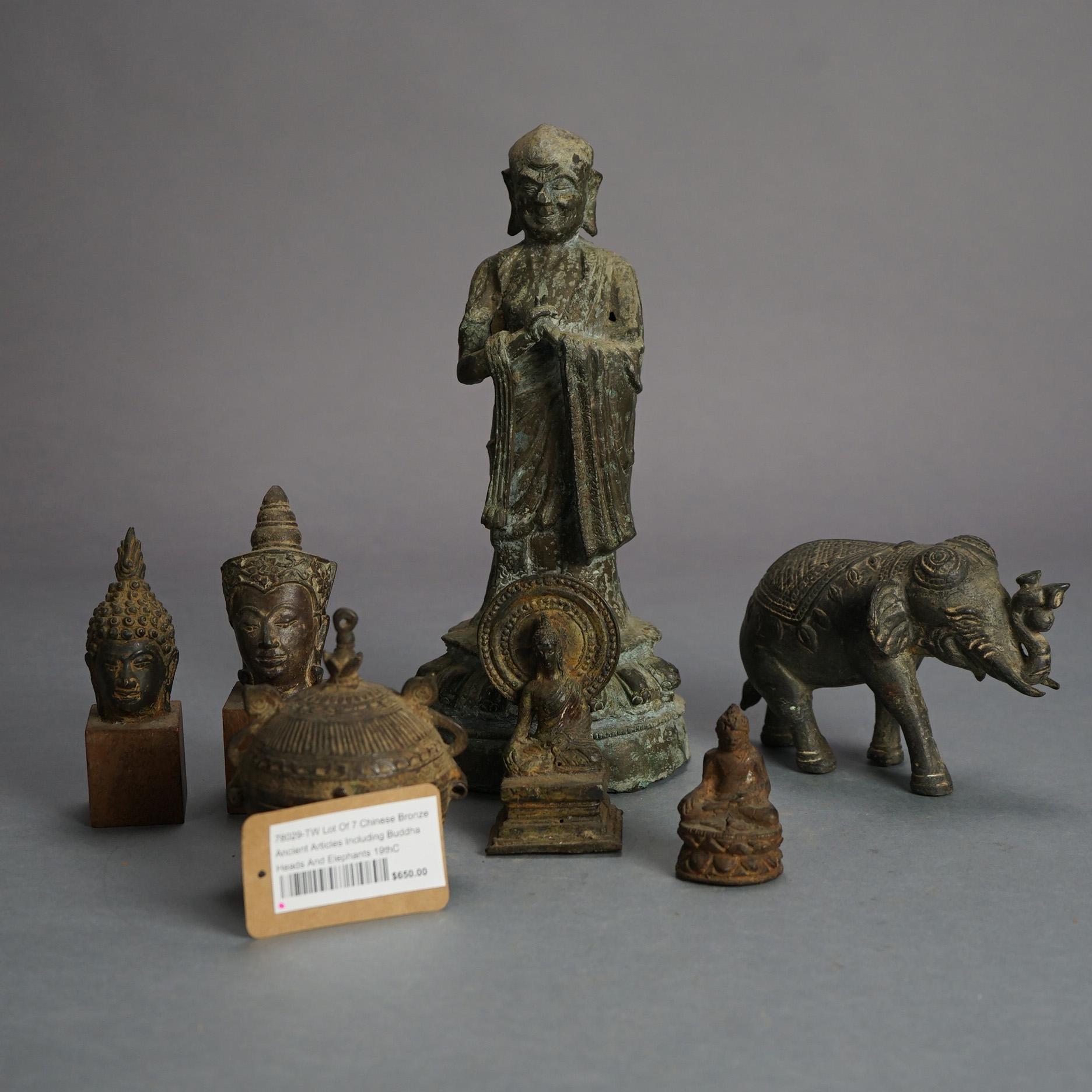 Seven Chinese Cast Bronze Ancient Articles Including Buddha Heads and Elephants 19thC

Measures - 10.5
