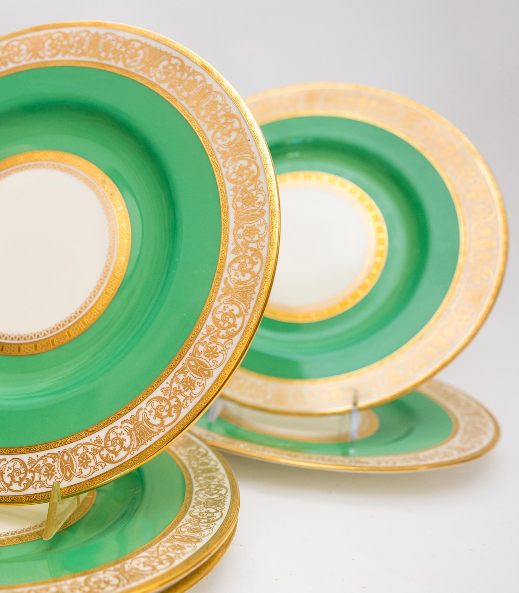 A custom ordered set of dinner plates from the Gilded Age Retailer Davis Collamore New York Circa 1905. This set of 7 plates has a nice wide green collar with triple 24 karat gold bands and finely decorated gold design. In wonderful antique