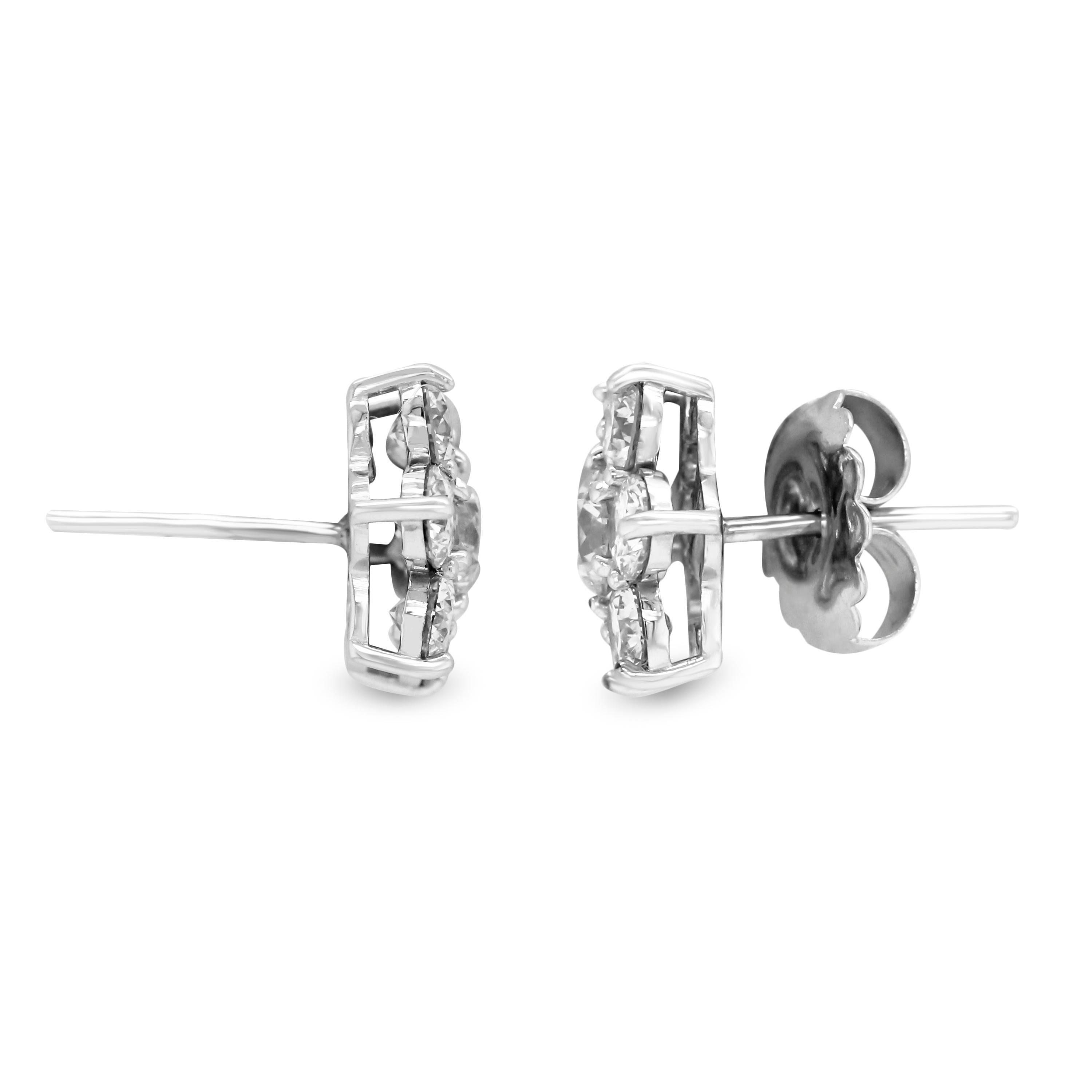 Seven Diamond 3.68 Carat 18K White Gold Cluster Stud Earrings

3.68 carat apprx. G color, VS clarity

Earrings are 0.55 inch width.

Centers are apprx. 0.45ct. each with apprx. 0.22-0.24ct. on the sides.