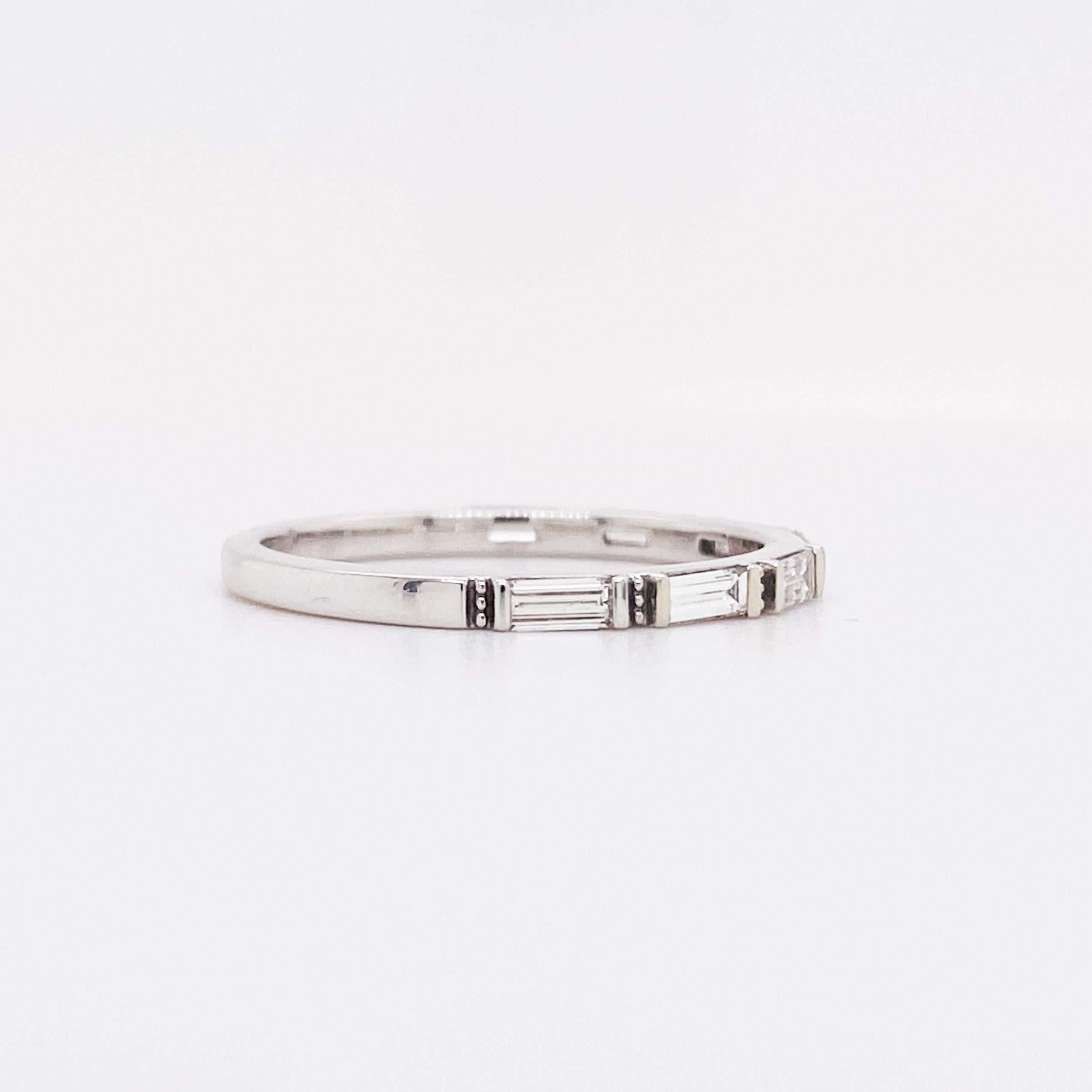 This slender baguette diamond band is perfect to stack up with your ring against its smooth flat sides. The clean lines of the horizontal row of seven baguettes are accented between each stone with a vertical row of dots. The ring design compliments