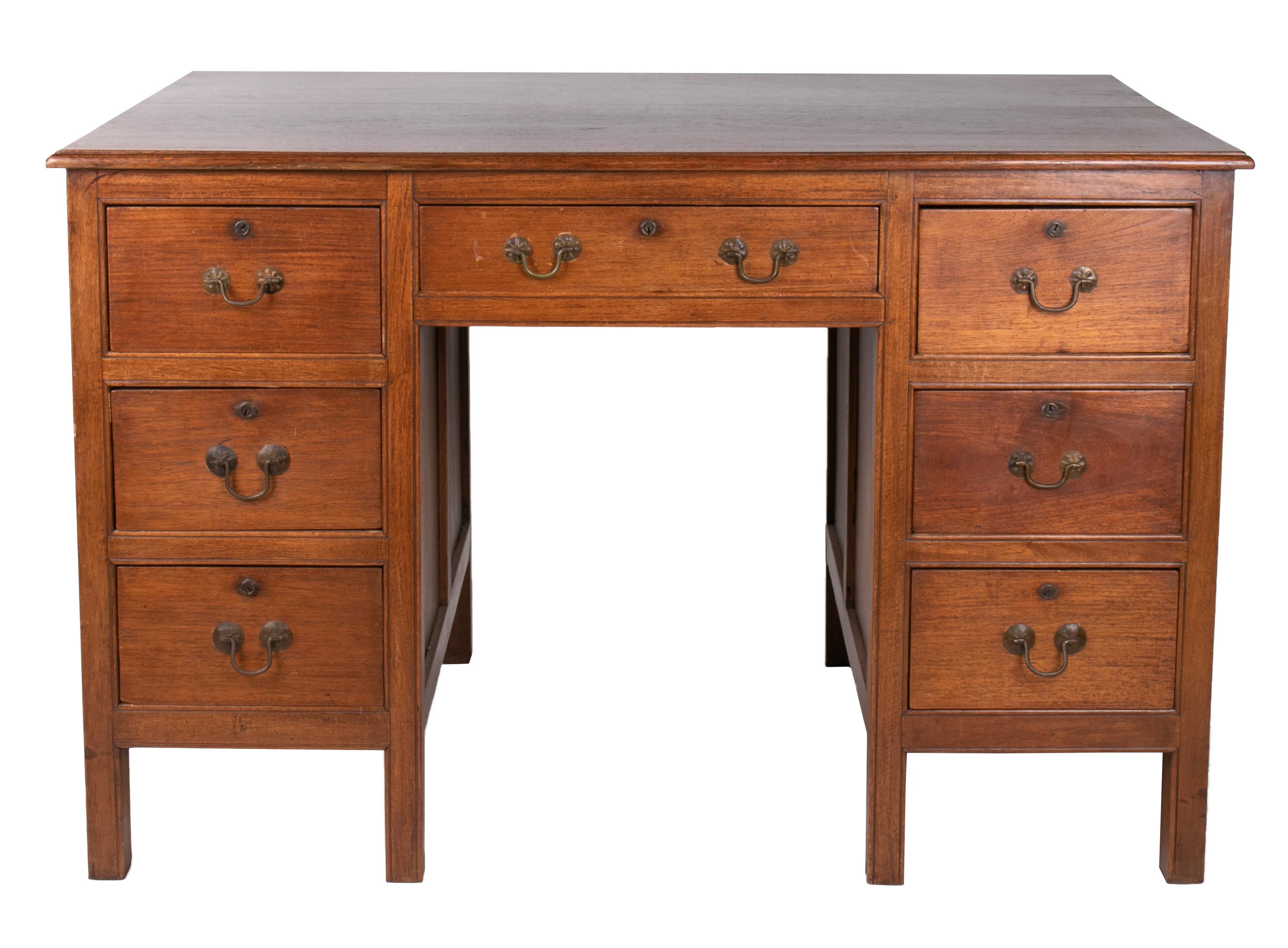 Seven drawer executive desk with brass handles, from Singapore.