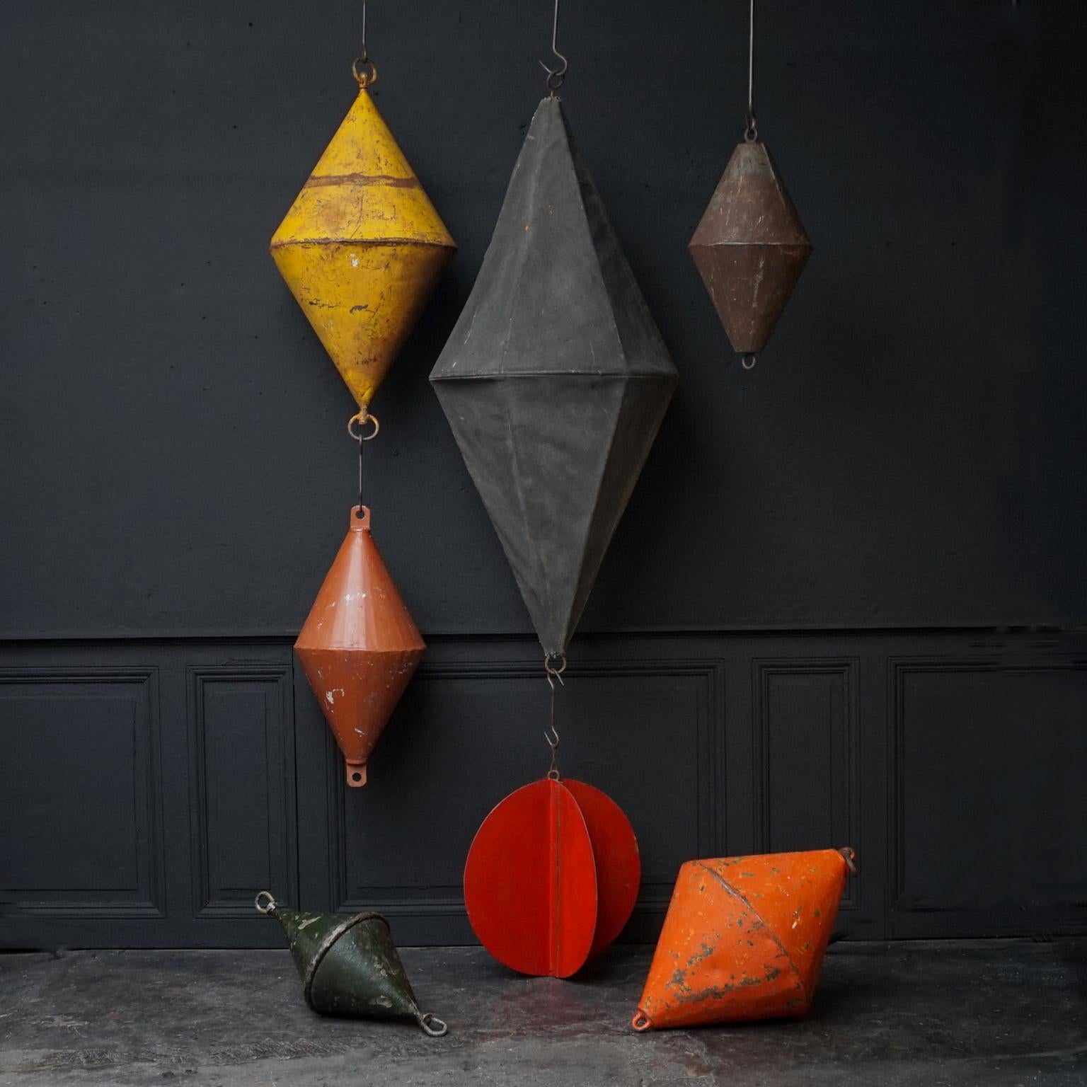 Set of seven very decorative antique early 1920s Dutch marine signal day shapes and metal buoys.
Two signal day shapes and five metal buoys. 
Six of them are diamond or biconical shaped, one, the metal red one, shaped like a ball.

A day shape is a