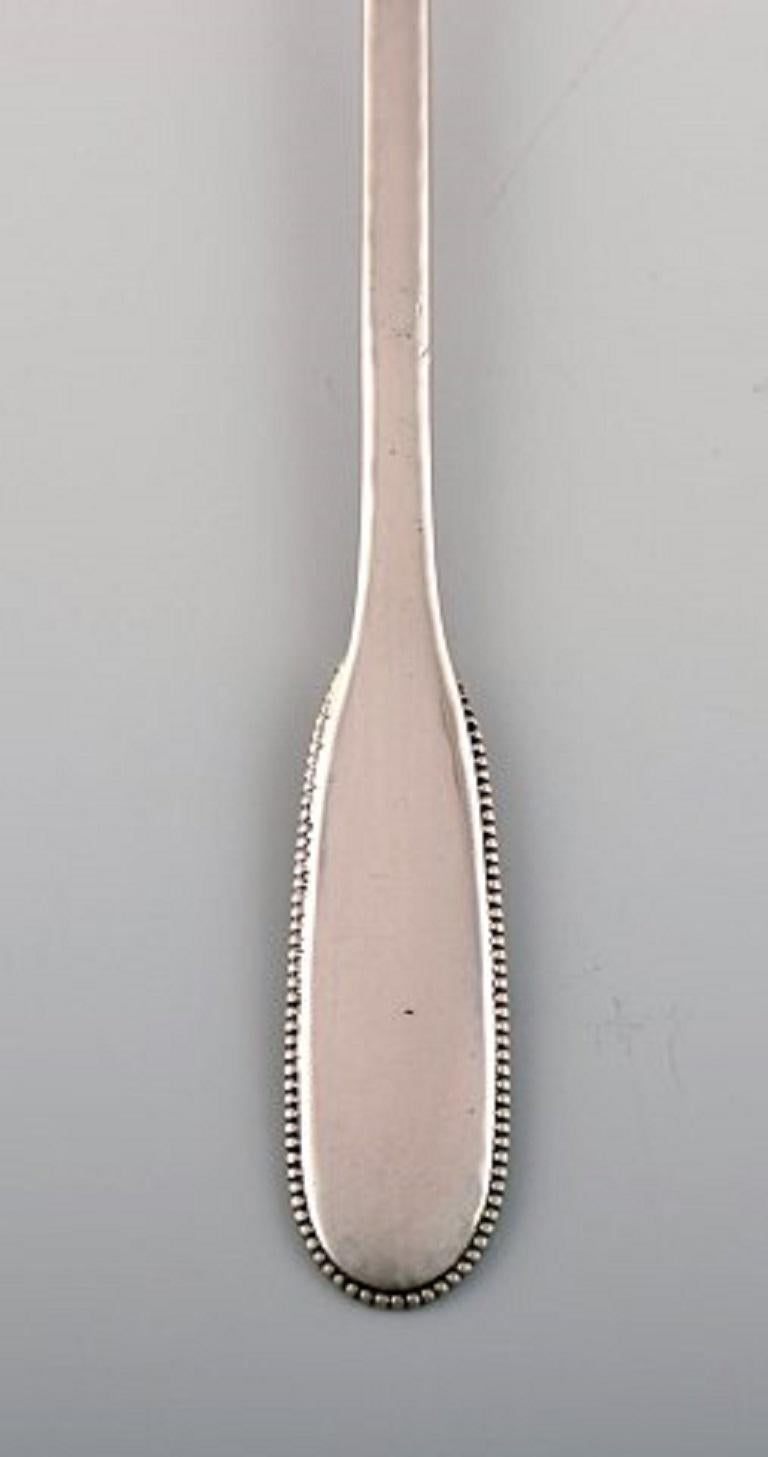 Art Deco Seven Evald Nielsen Number 14 Iced Tea Spoons in Hammered Silver, 1920s. 