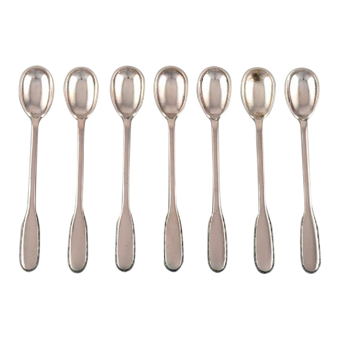 Seven Evald Nielsen Number 14 Iced Tea Spoons in Hammered Silver, 1920s. 
