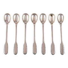 Seven Evald Nielsen Number 14 Iced Tea Spoons in Hammered Silver, 1920s. 