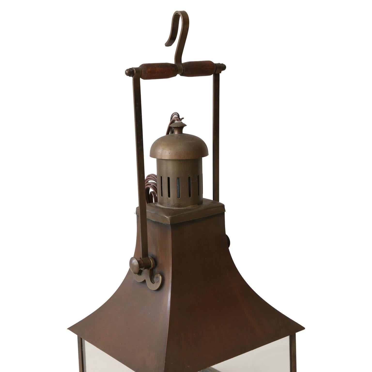 Three French antique tole lanterns with glazed panels and nice wooden handles. Newly-wired for single medium-base size bulbs. Include extra chain and original canopies. Sold individually and priced $1,700 each.